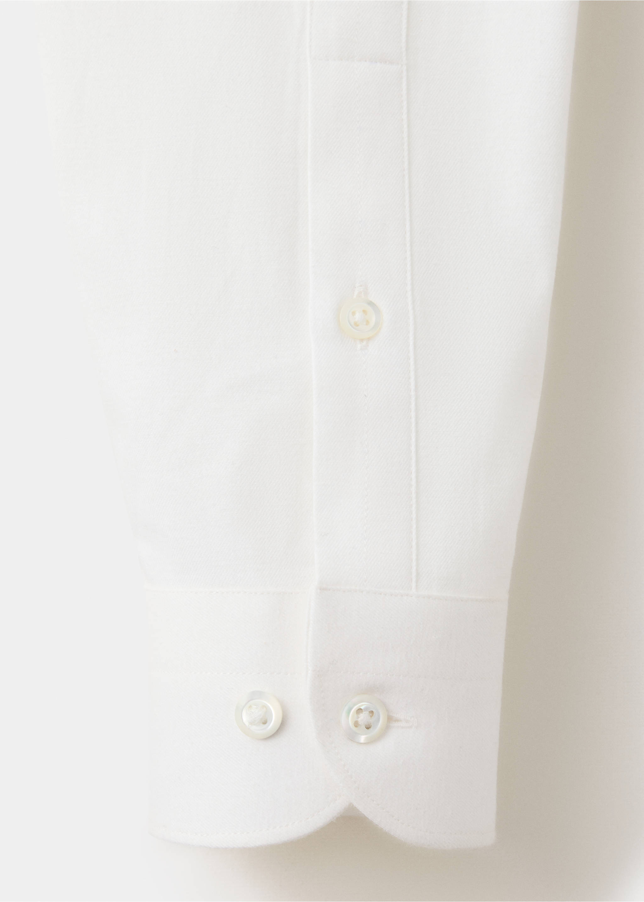 White shirt fabric detail showing the buttoned cuff and sleeve placket., White. Ref: 37017939-00.