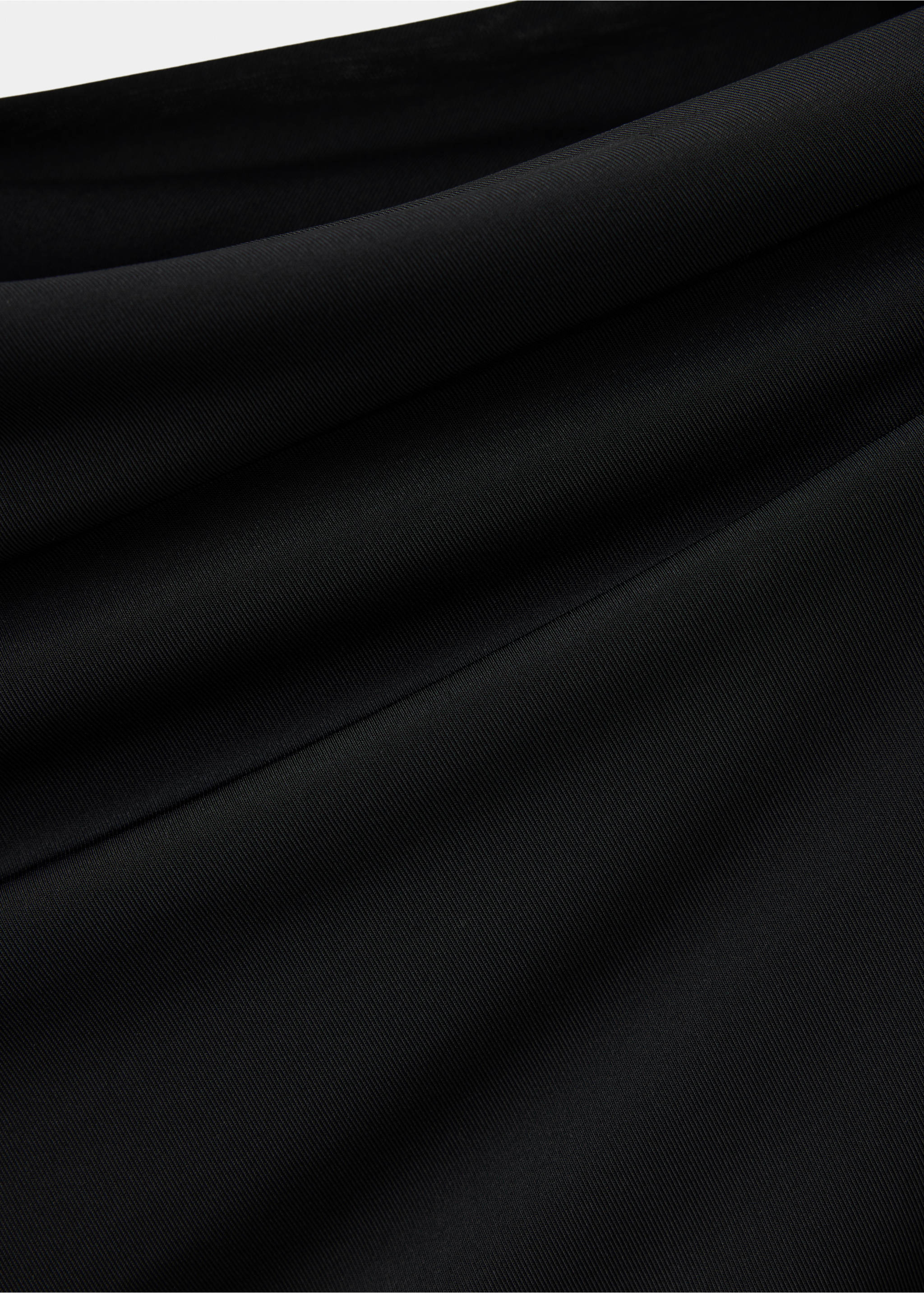 Close-up of the smooth black fabric texture on a dress., Black. Ref: 37017942-00.