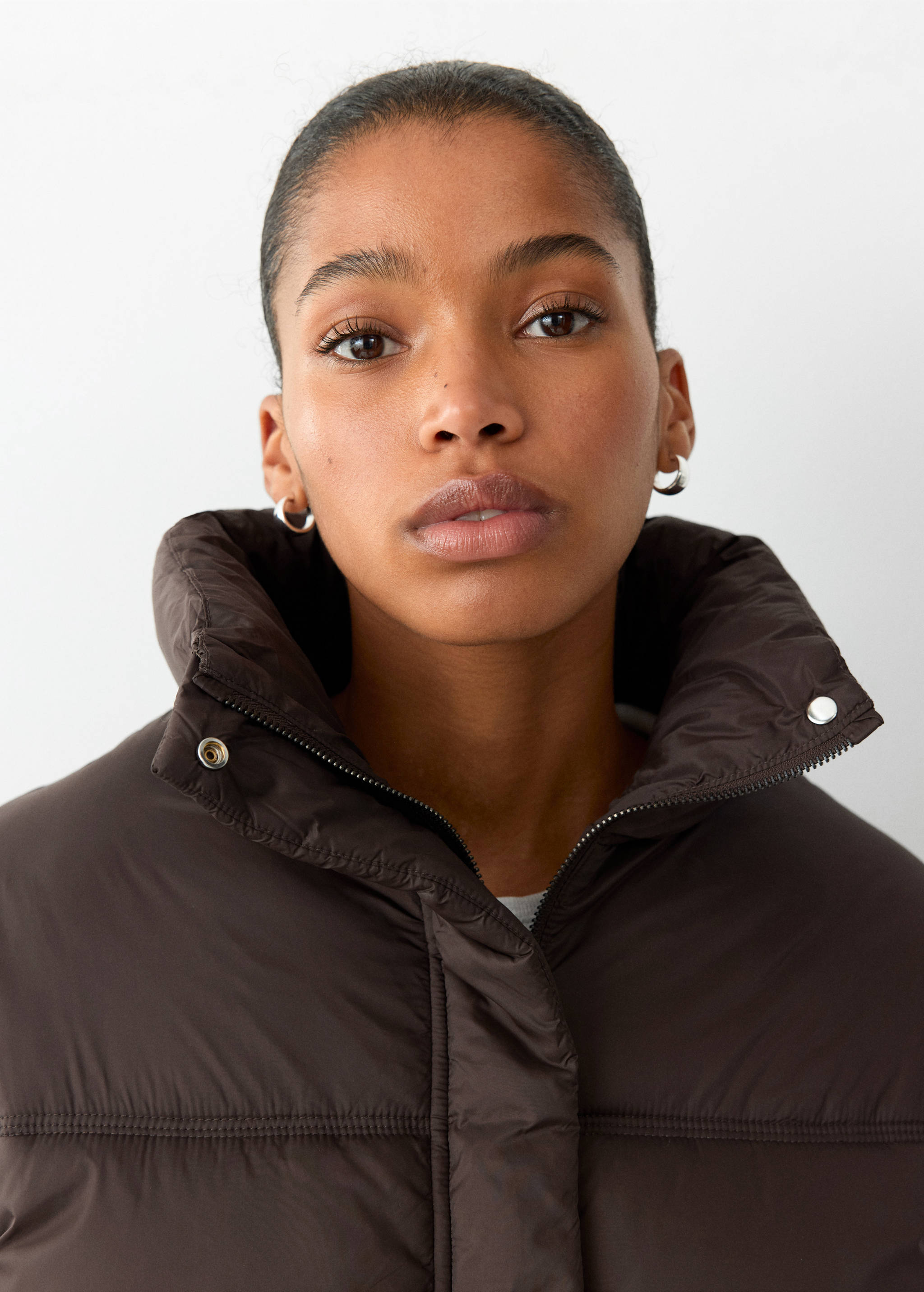 Close-up of a dark brown anorak with a high collar.