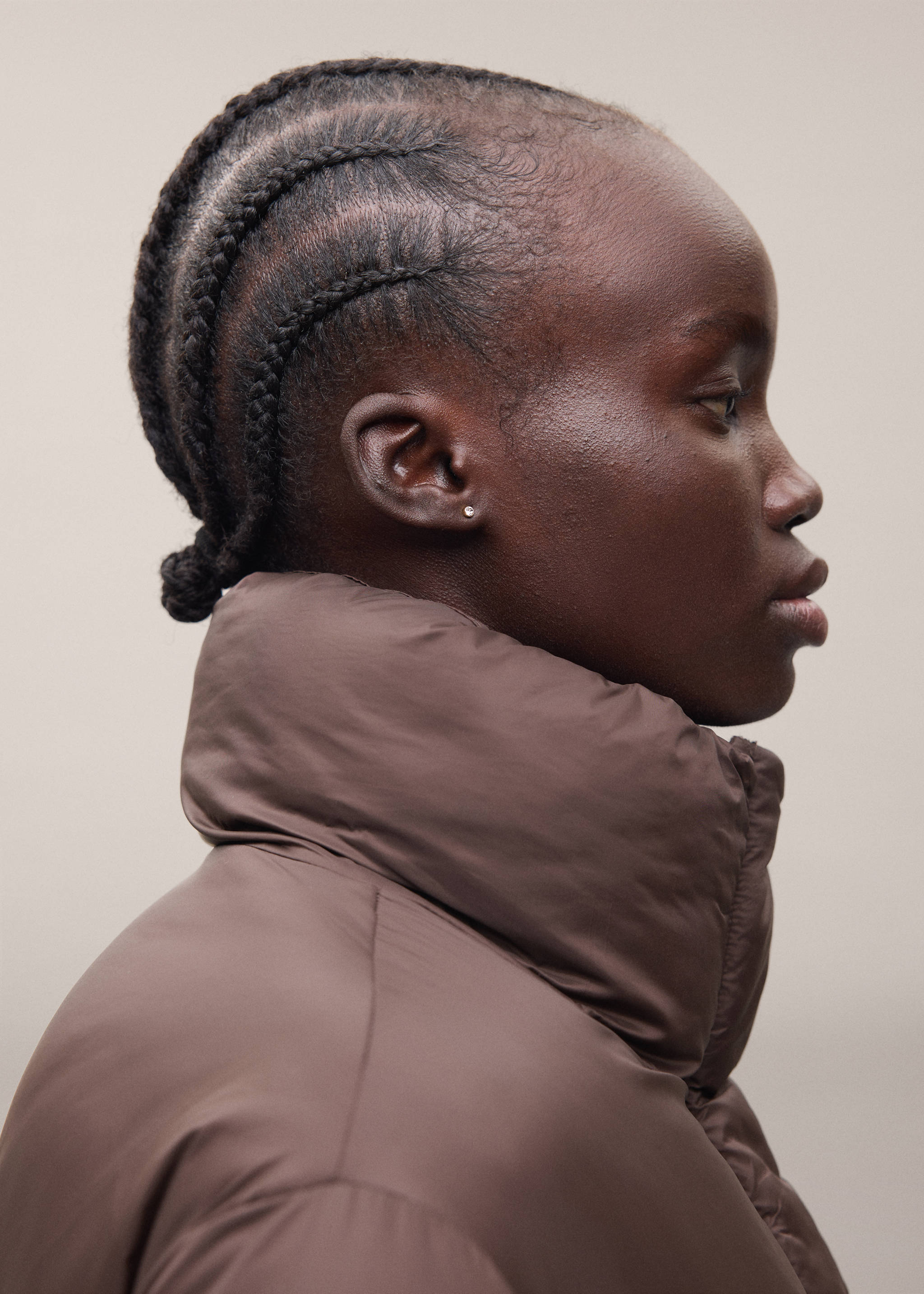 Brown puffer anorak featuring a high padded collar.