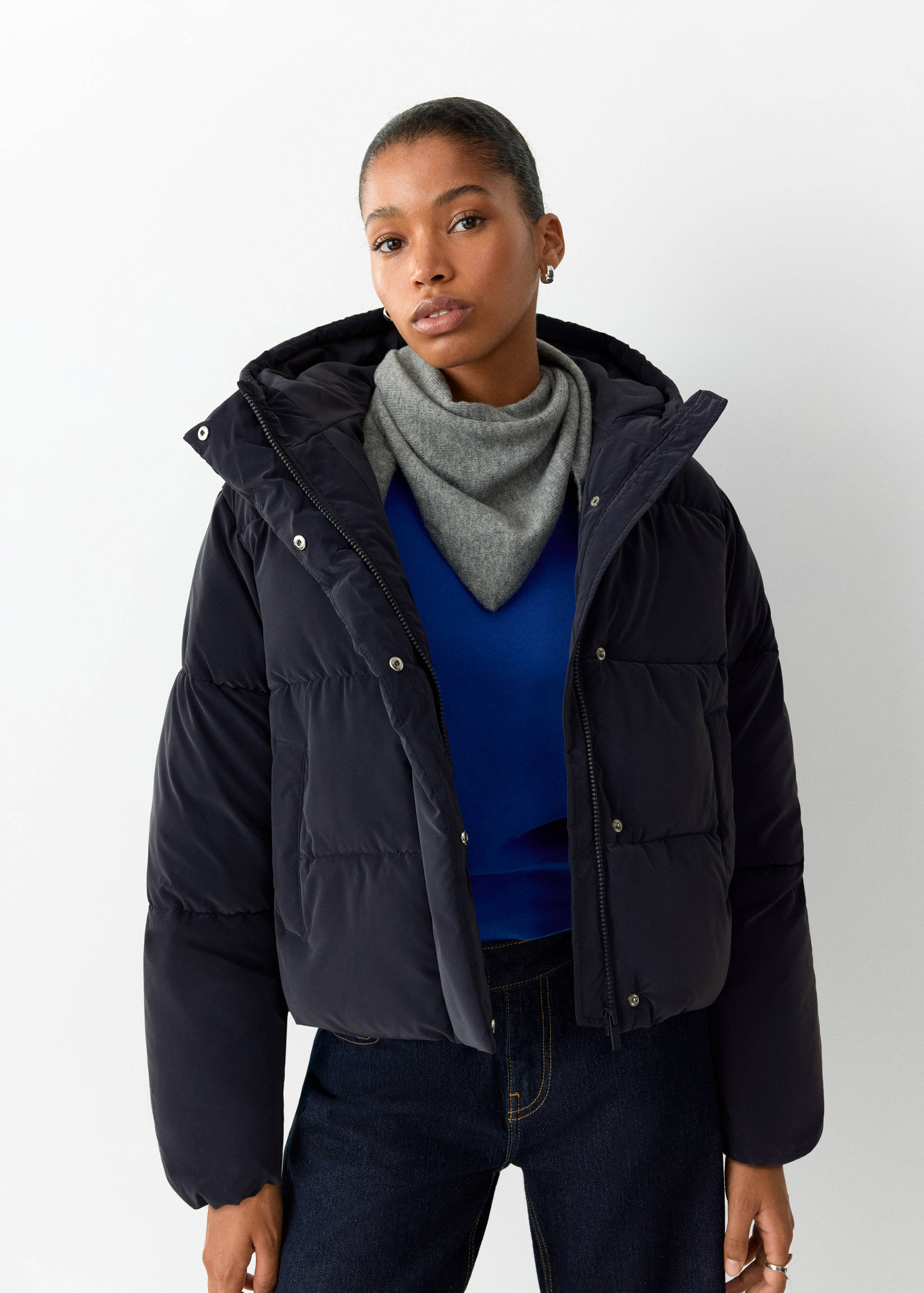 Dark blue hooded quilted anorak with a front zip fastening.