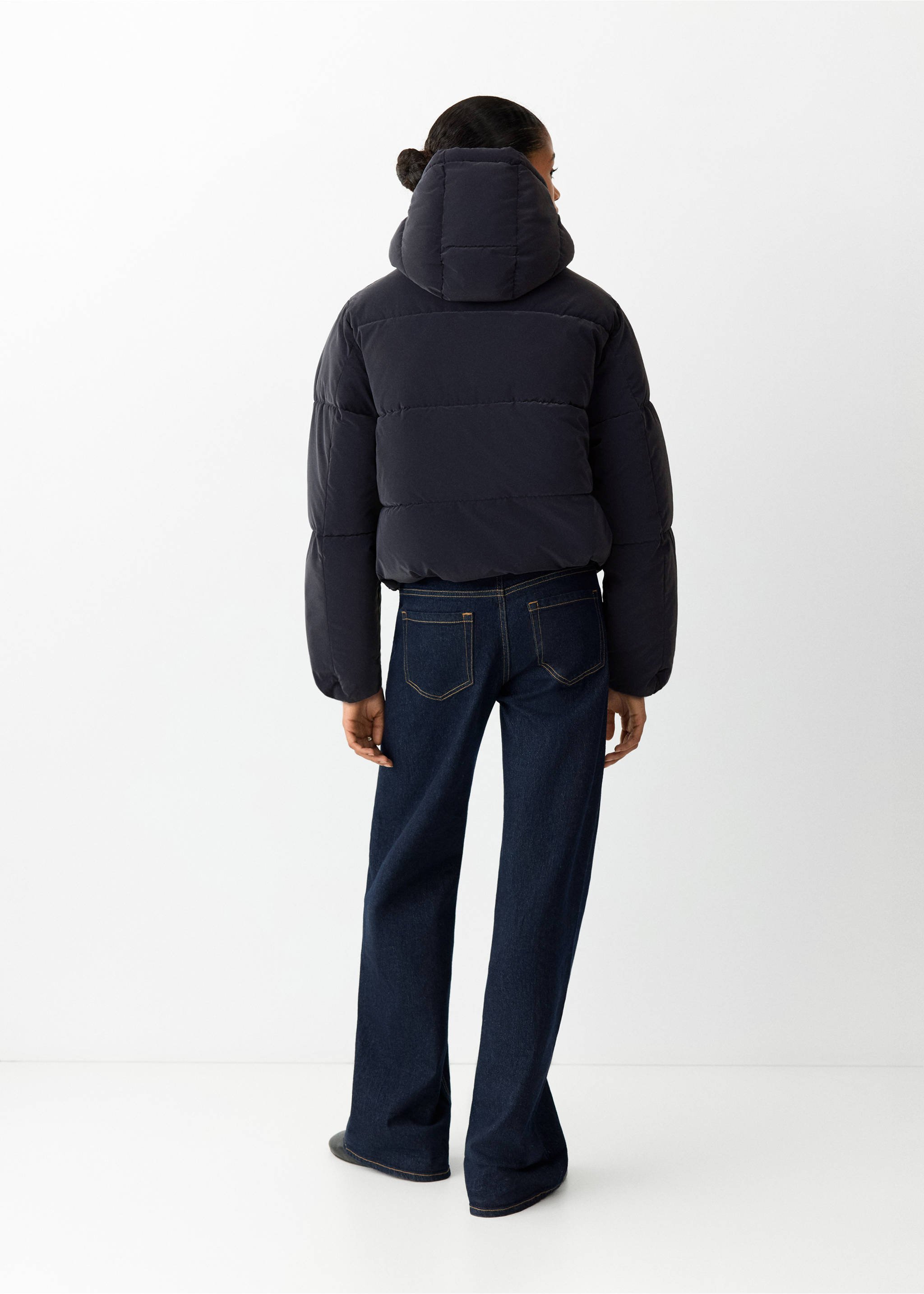 Navy blue quilted anorak viewed from the back, paired with denim trousers., Navy. Ref: 37018266-00.