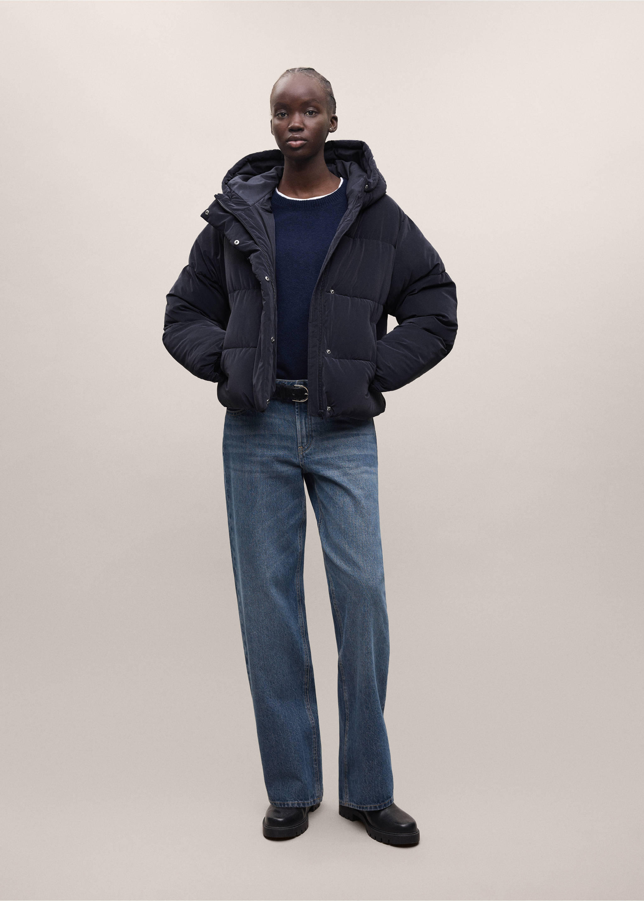 Navy blue quilted anorak with a hood and horizontal baffles, worn with a jumper, blue jeans, and boots., Navy. Ref: 37018266-01.