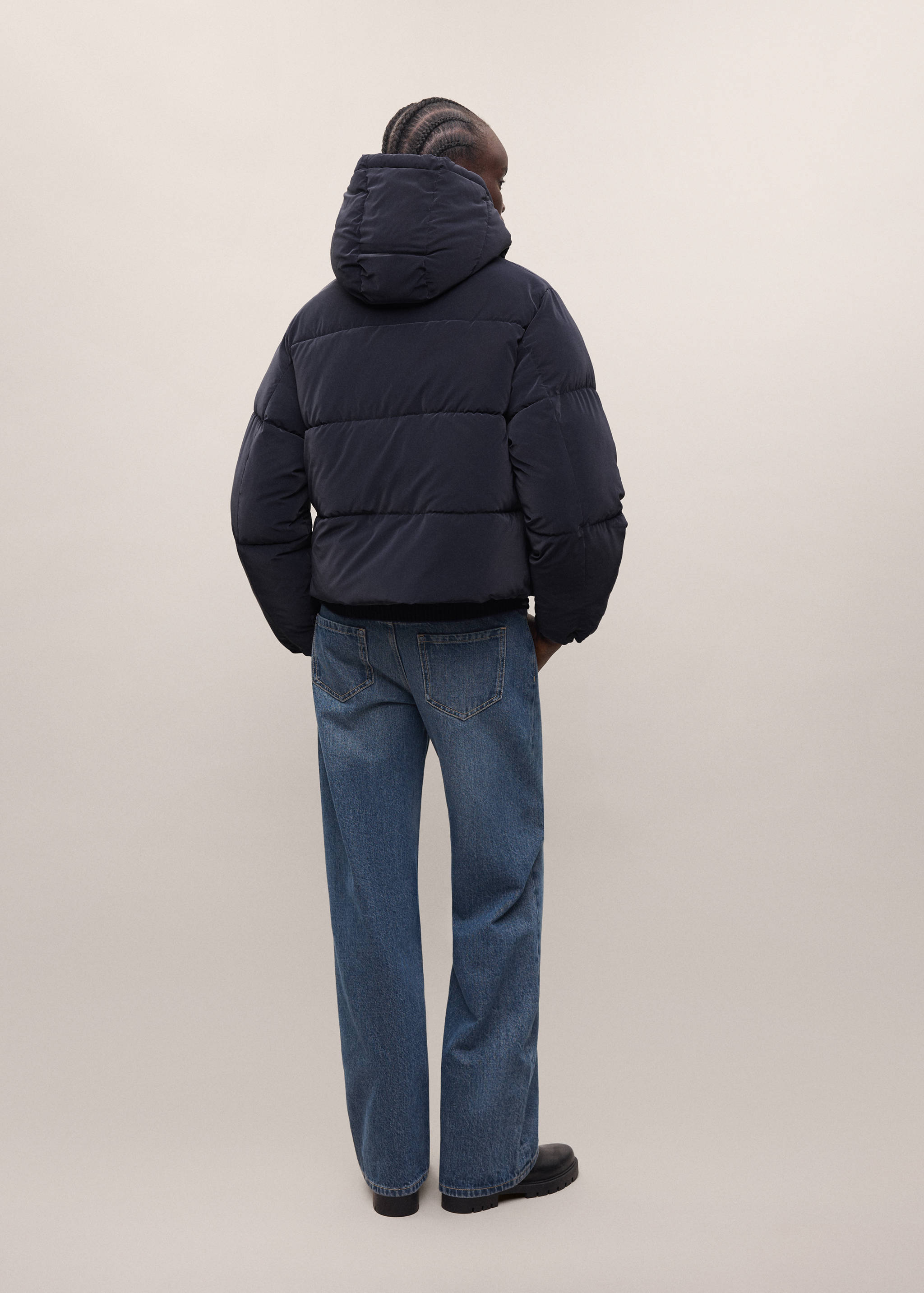 Back view of a dark navy blue hooded quilted anorak.