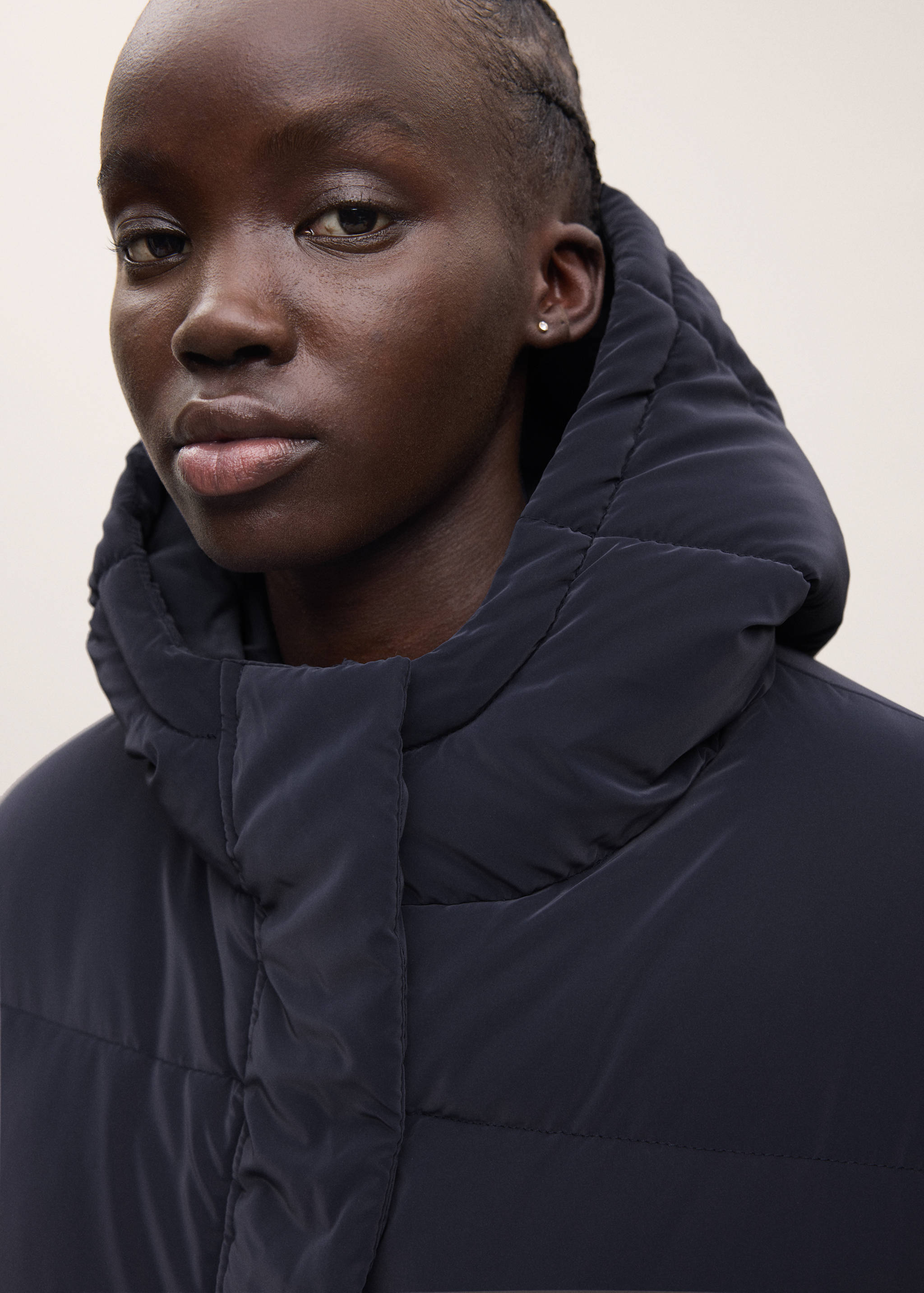 Navy blue hooded padded anorak, close-up view.