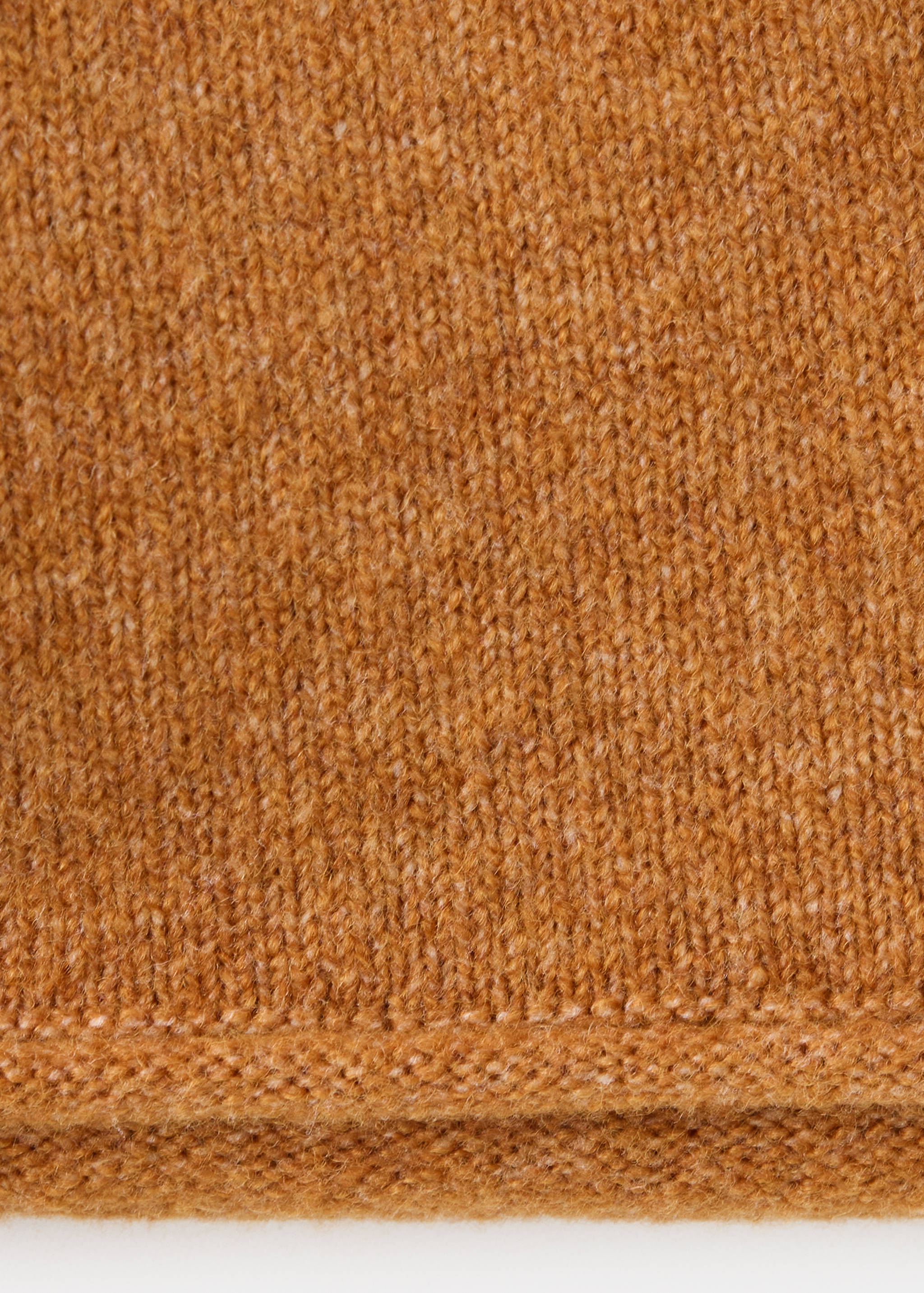 Detalle de la textura del tejido del jersey de punto marrón.