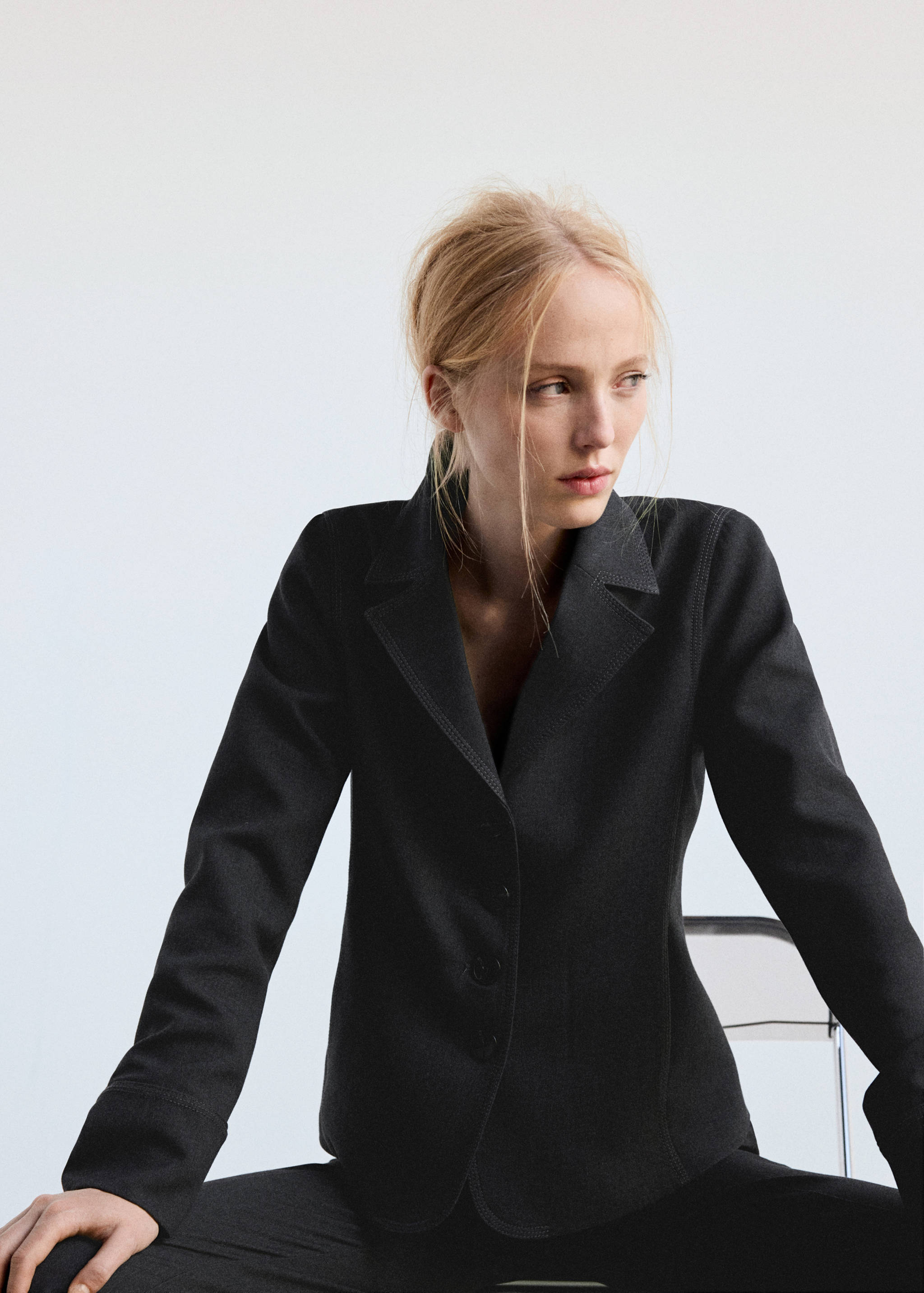 Dark grey tailored blazer with notched lapels and button fastening.
