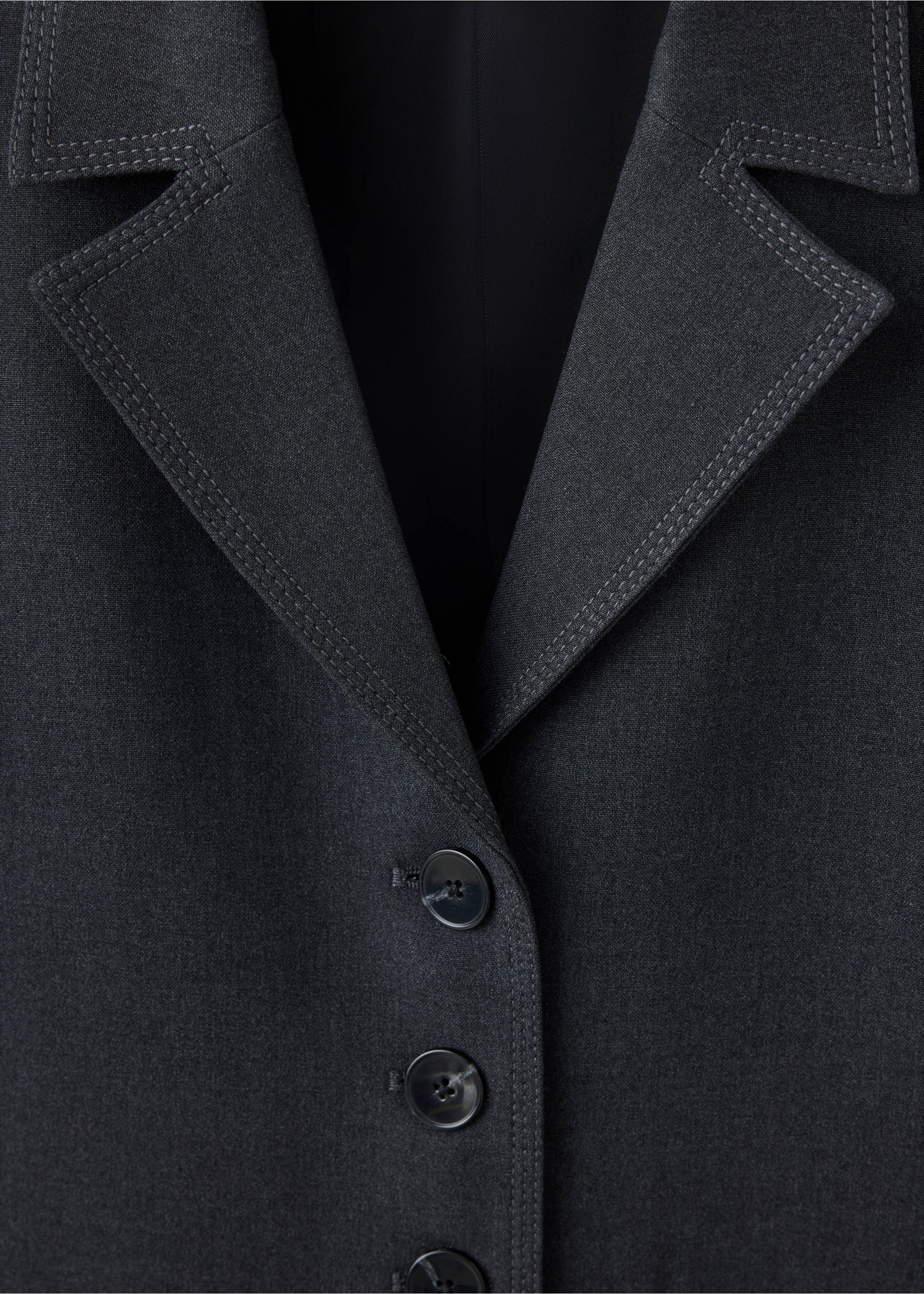 Close-up of a dark grey blazer with topstitched lapels and three buttons., Grey. Ref: 37018290-00.