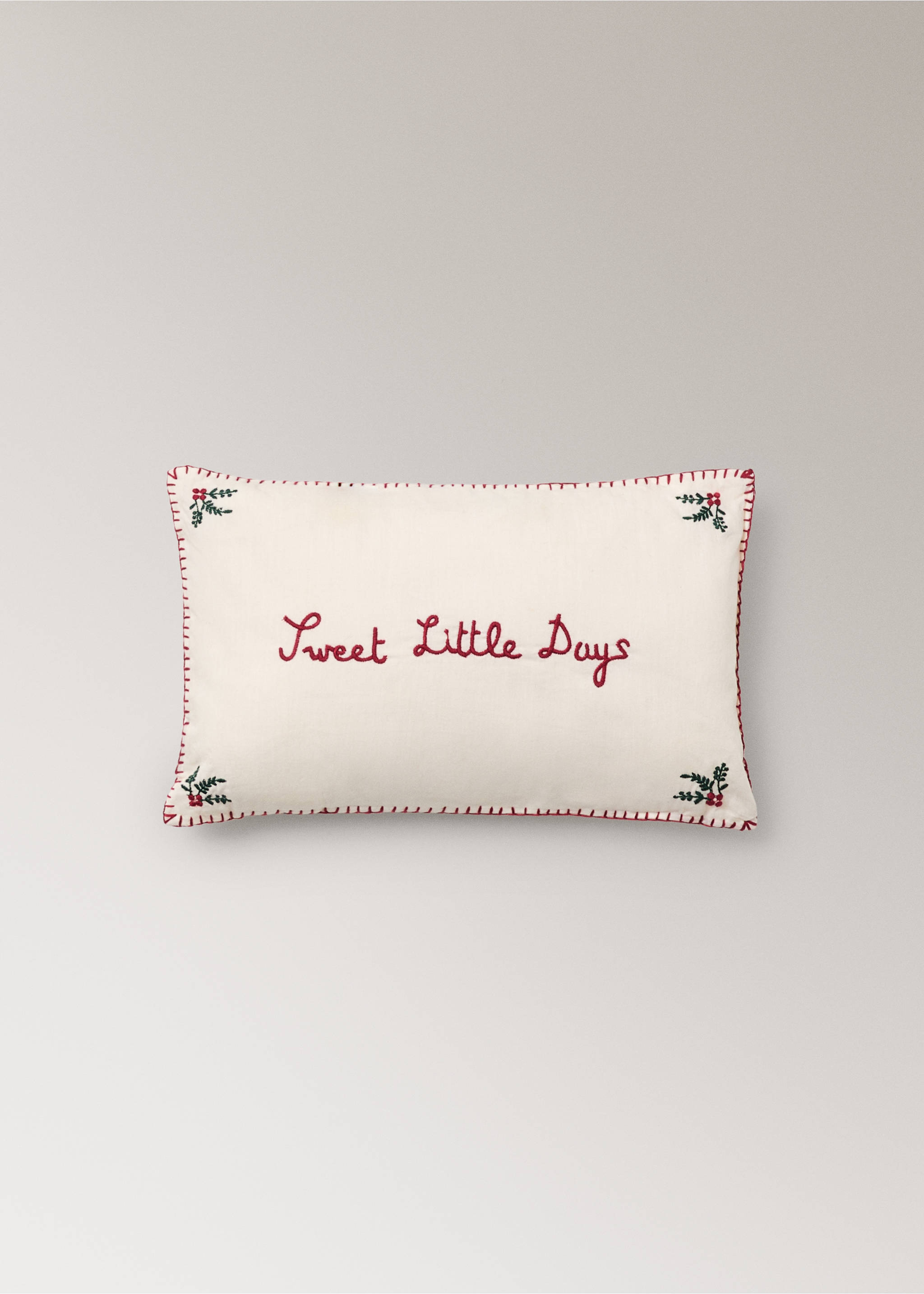 Off-white cushion with red embroidered stitching, text, and corner botanical details., Red. Ref: 37018637-00.