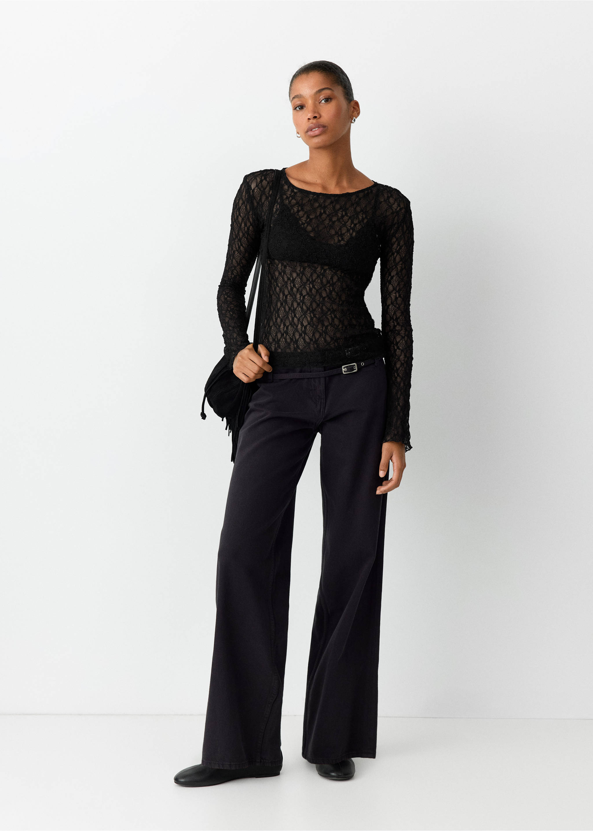 Black sheer lace long-sleeved t-shirt worn with dark grey trousers., Black. Ref: 37019123-00.