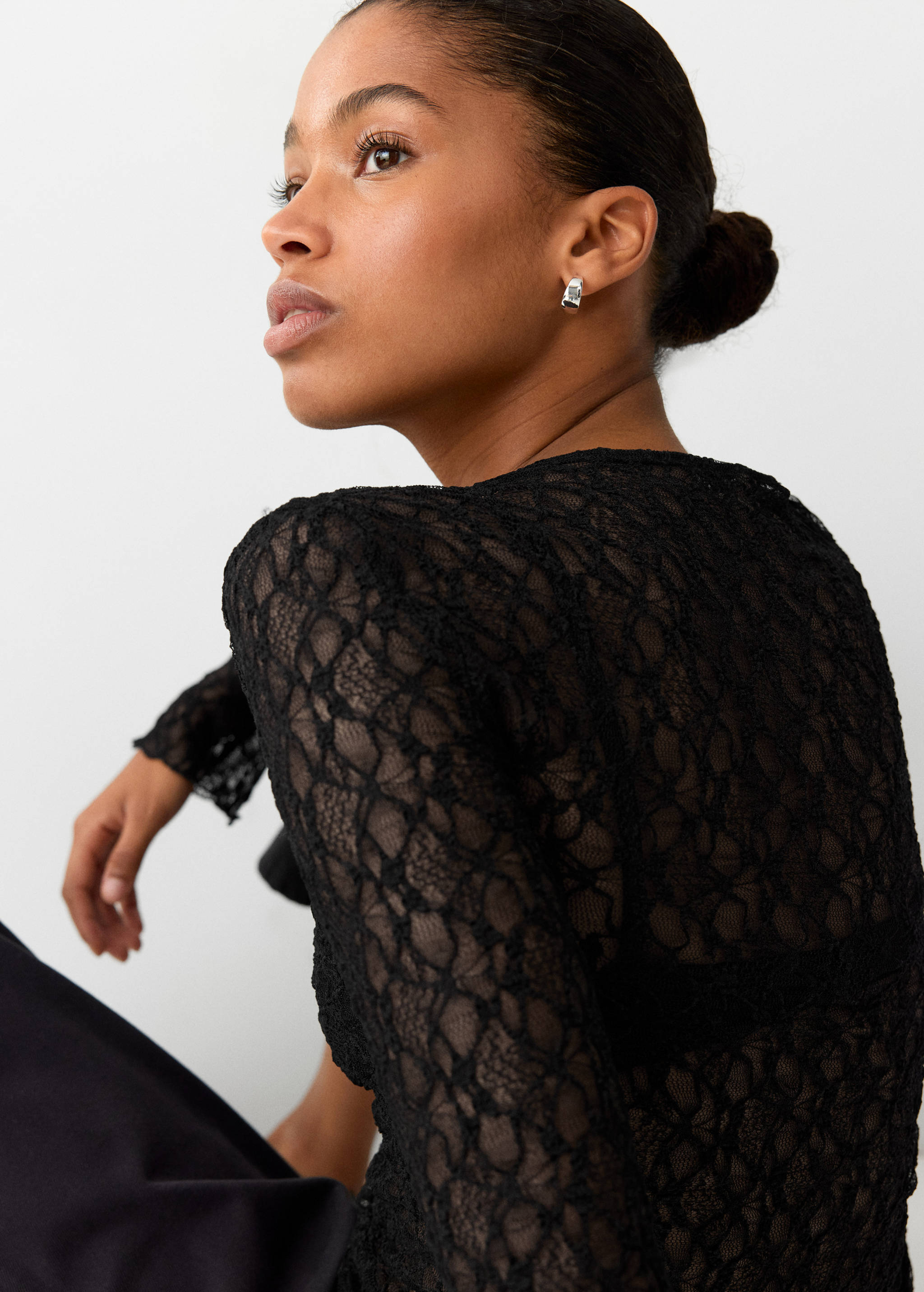 Black lace long-sleeved t-shirt with a fitted silhouette.