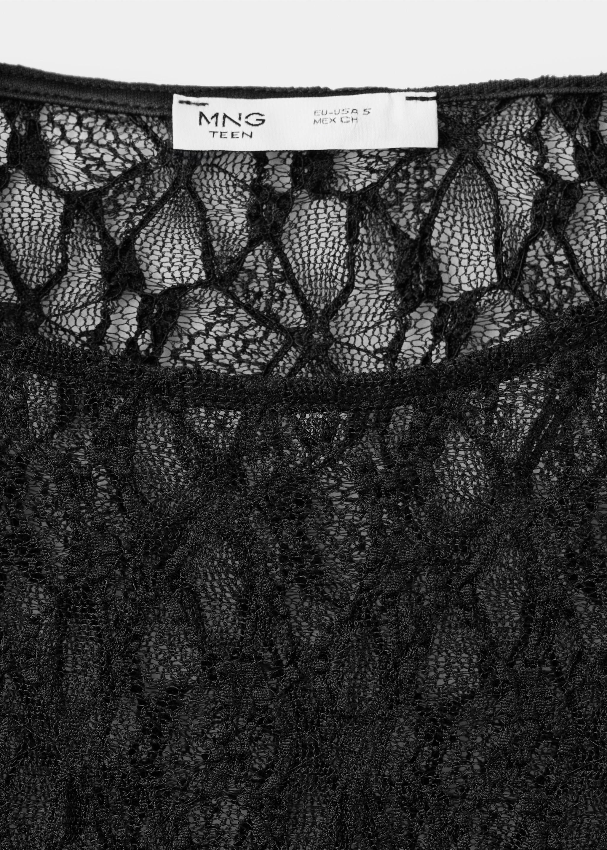 Close-up of the interior label and sheer black lace fabric on a t-shirt., Black. Ref: 37019123-00.
