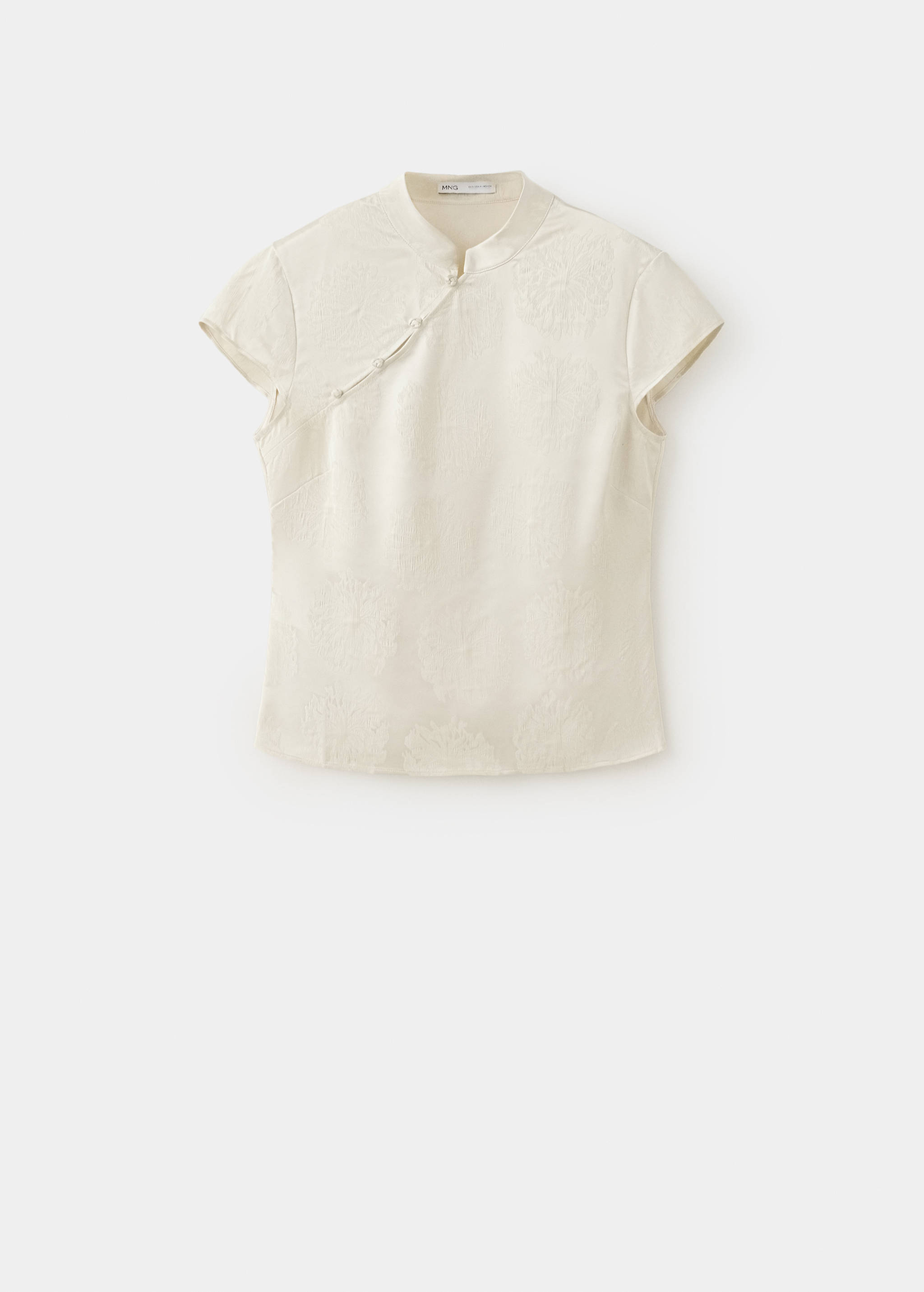 Blusa jacquard de manga corta en color blanco roto con cuello mao y cierres de nudo cruzados.