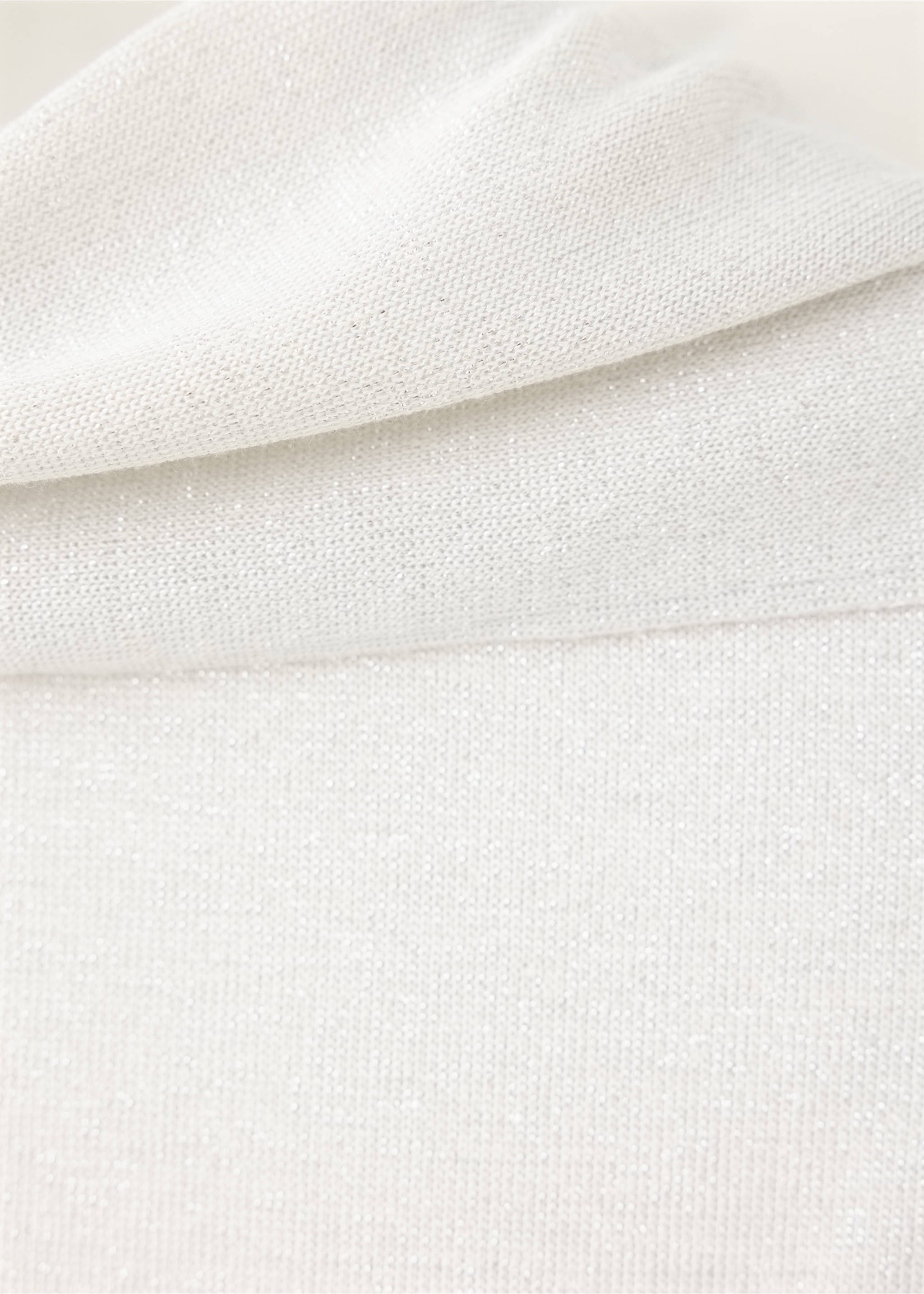 Close-up of a white knitted top showing the textured fabric and collar., Silver. Ref: 37019129-00.