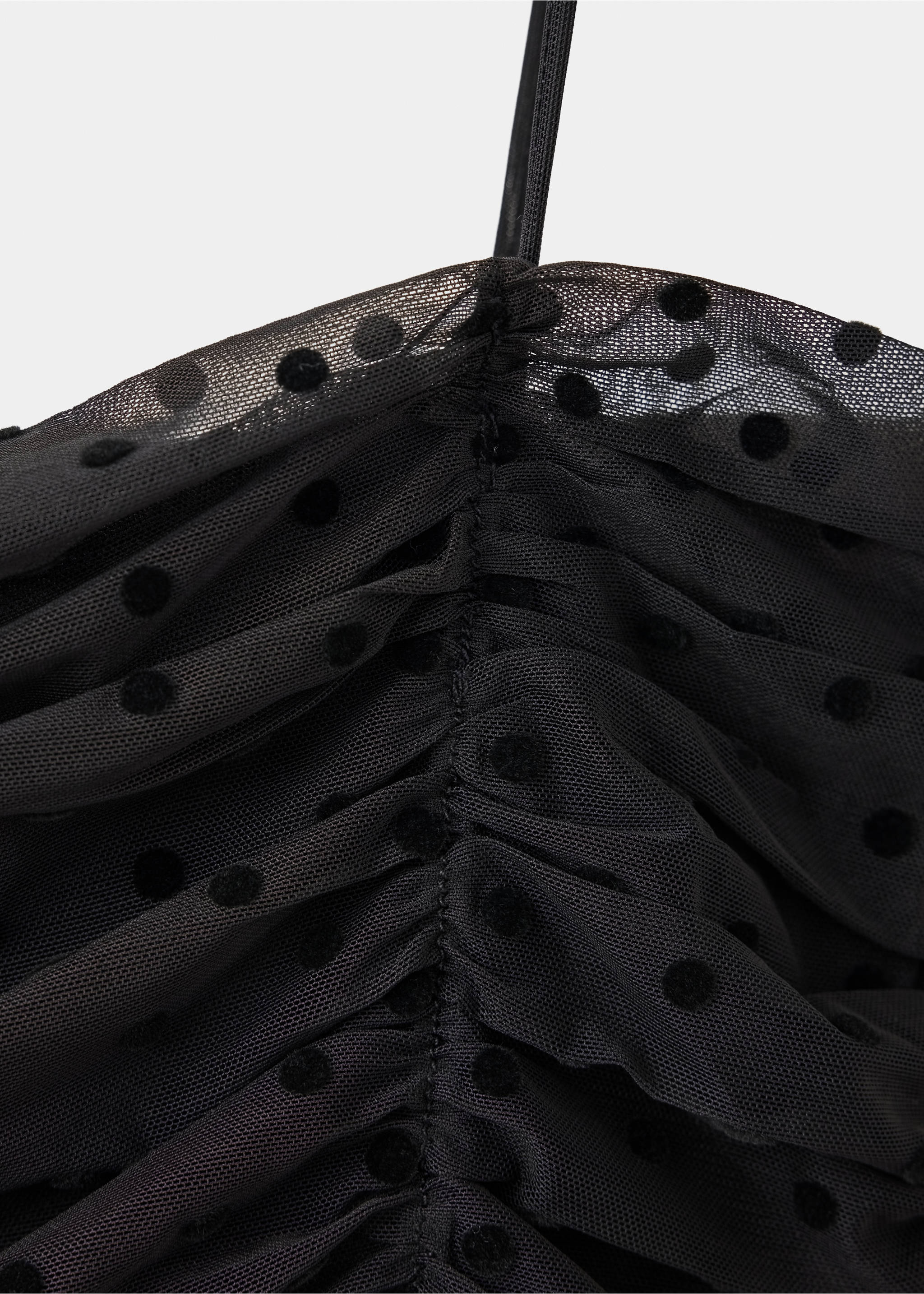Close-up of a black mesh top with ruching and a polka dot pattern., Black. Ref: 37019131-00.