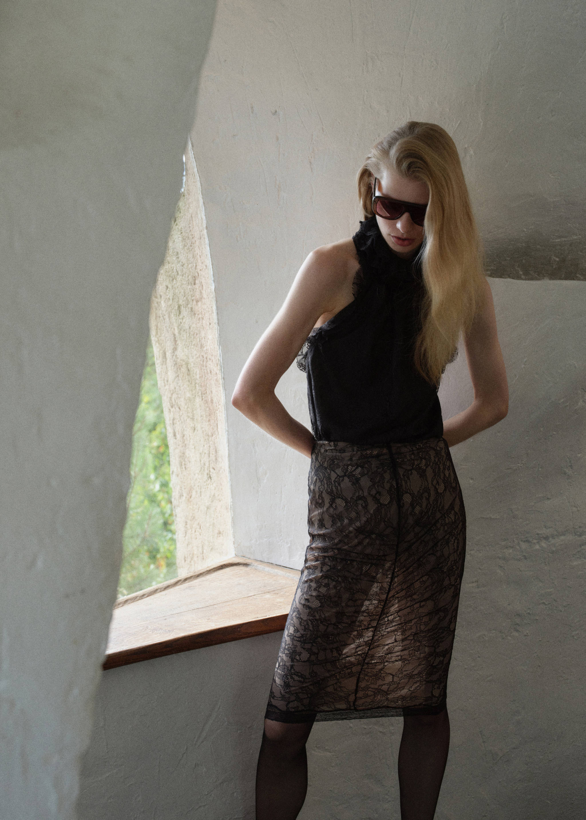 Black lace knee-length pencil skirt with nude lining.