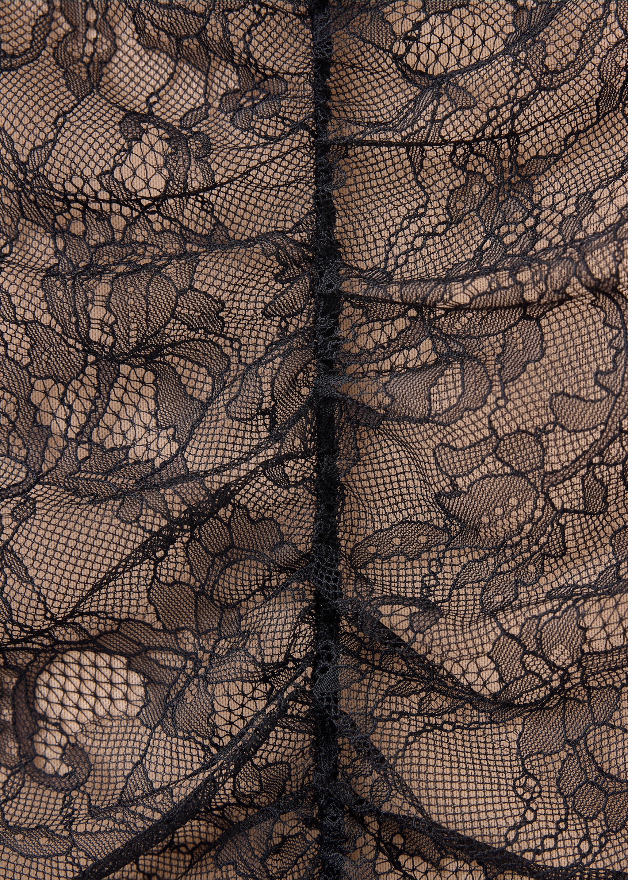 Close-up of a black floral lace skirt with a gathered central seam., Black. Ref: 37019133-00.