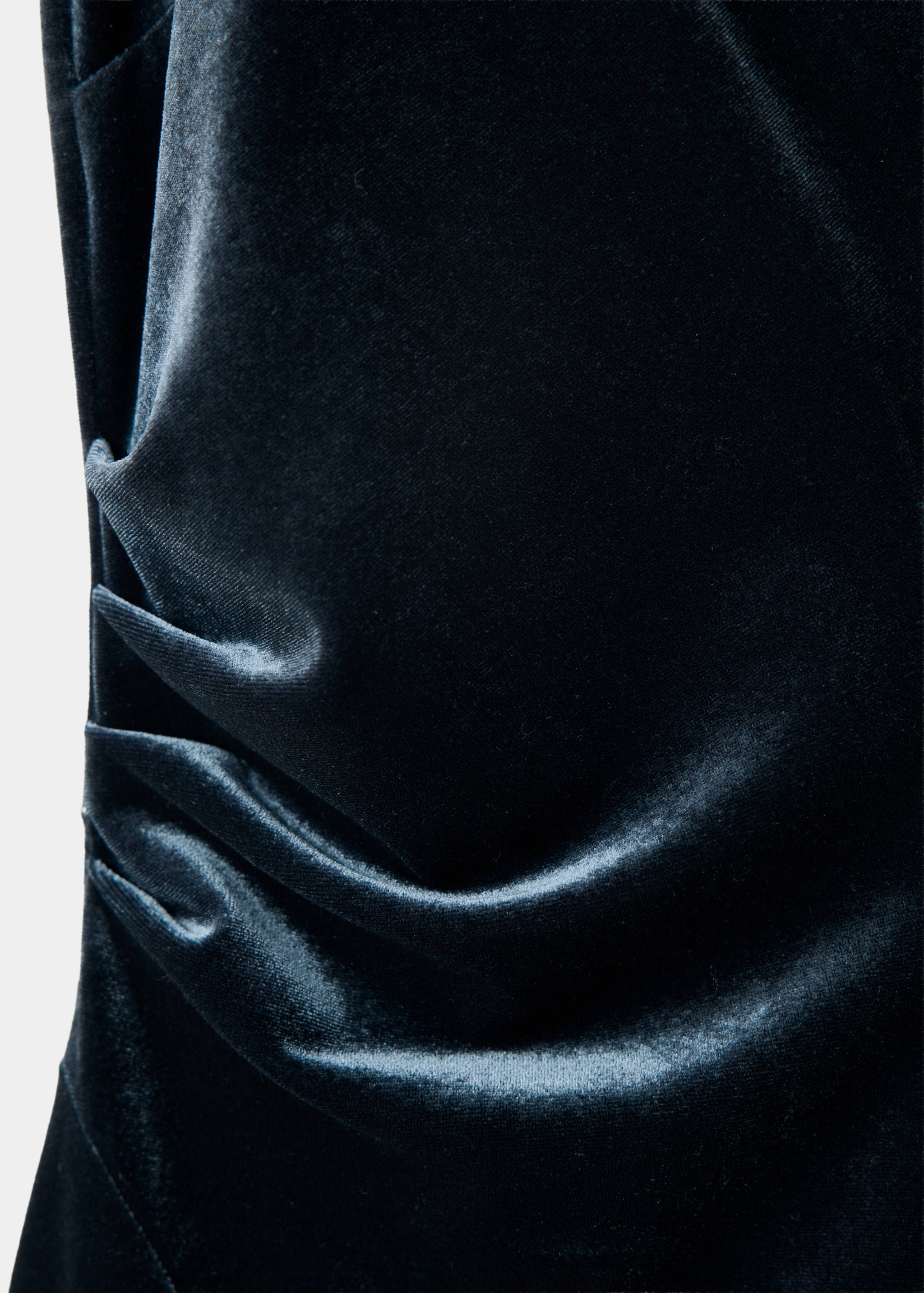 Dark teal velvet dress detail, showing gathered draping.