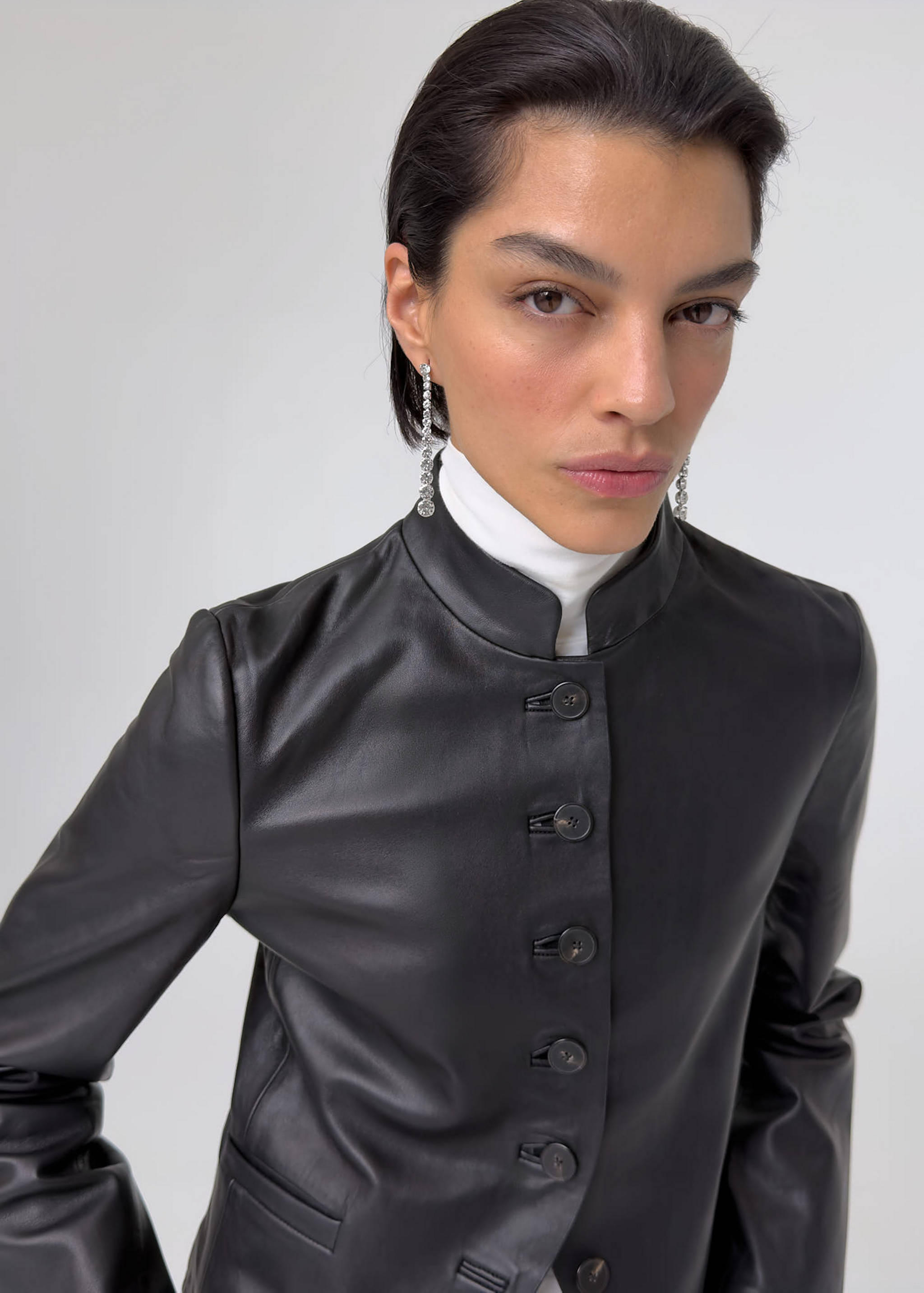 Sparkling rhinestone drop earrings worn by a model.
