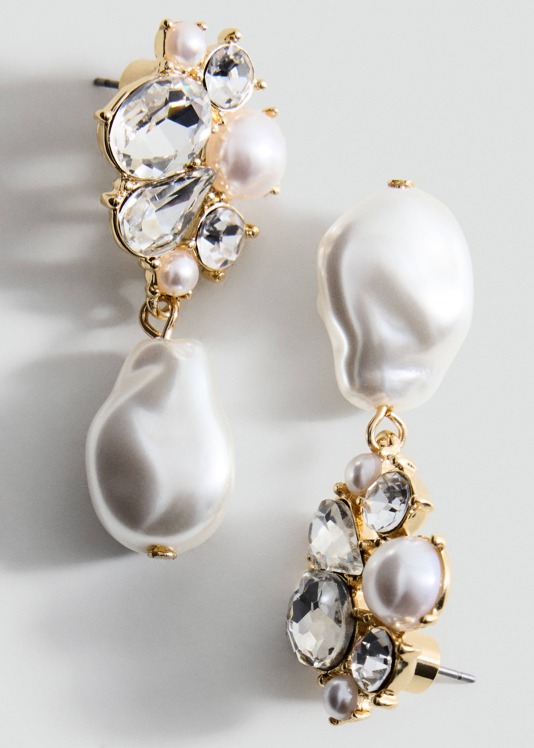 Gold-toned earrings featuring clusters of clear crystals and faux pearls.