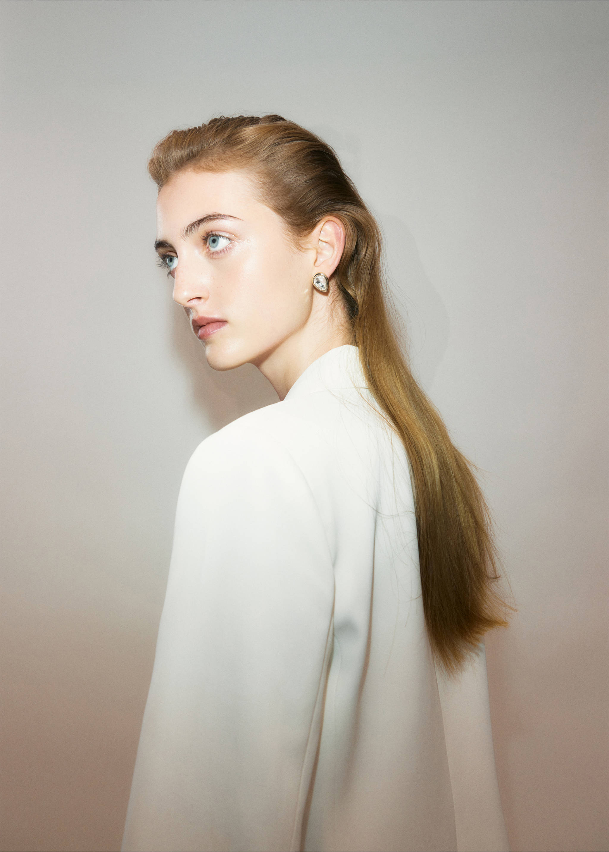 Metallic teardrop earring worn by a model in a white blazer., Gold. Ref: 37019147-00.