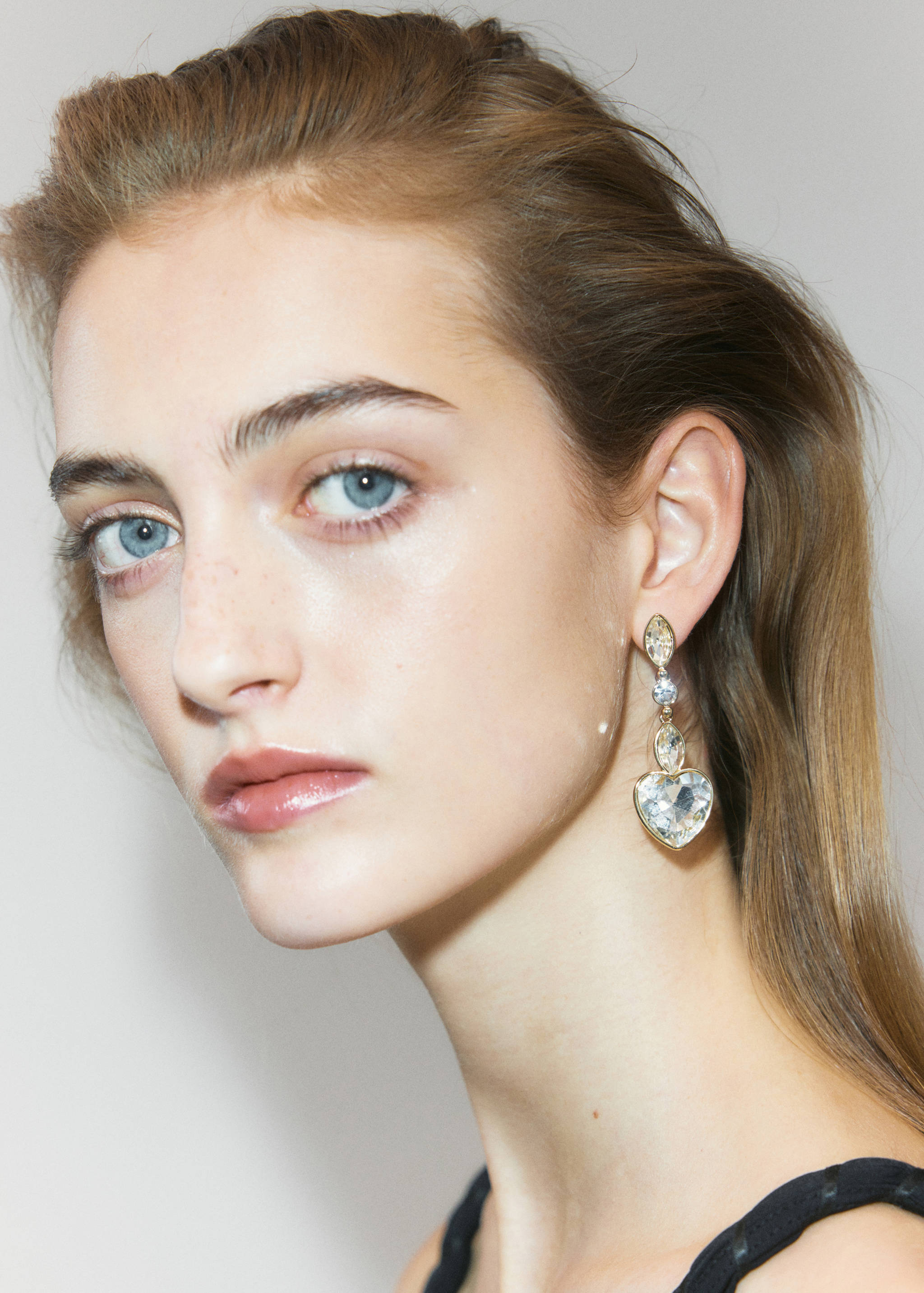 Gold-toned drop earring featuring faceted marquise, round, and heart-shaped crystals.