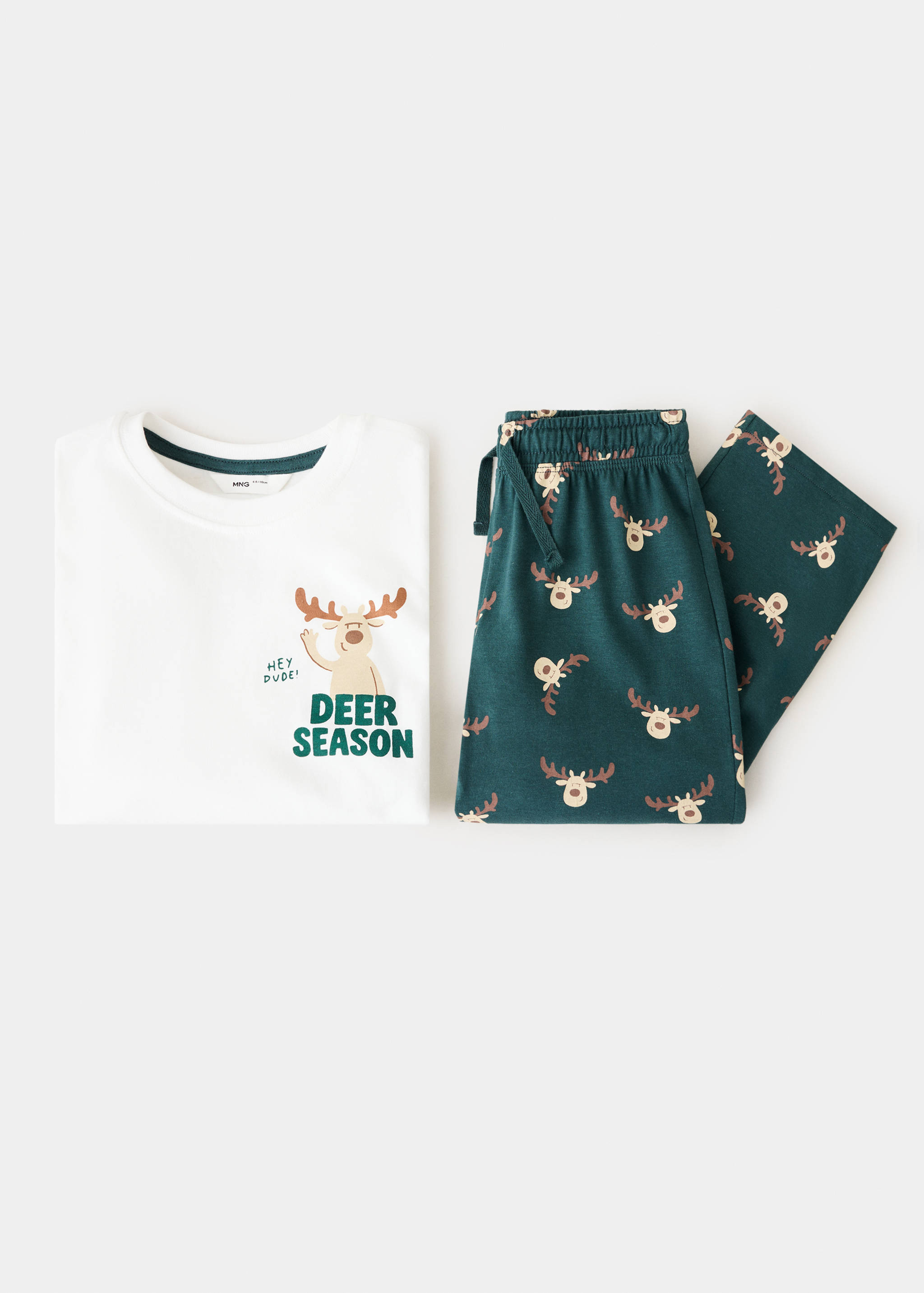 Children's pyjama set featuring a white top with a reindeer graphic and dark green reindeer-print trousers.