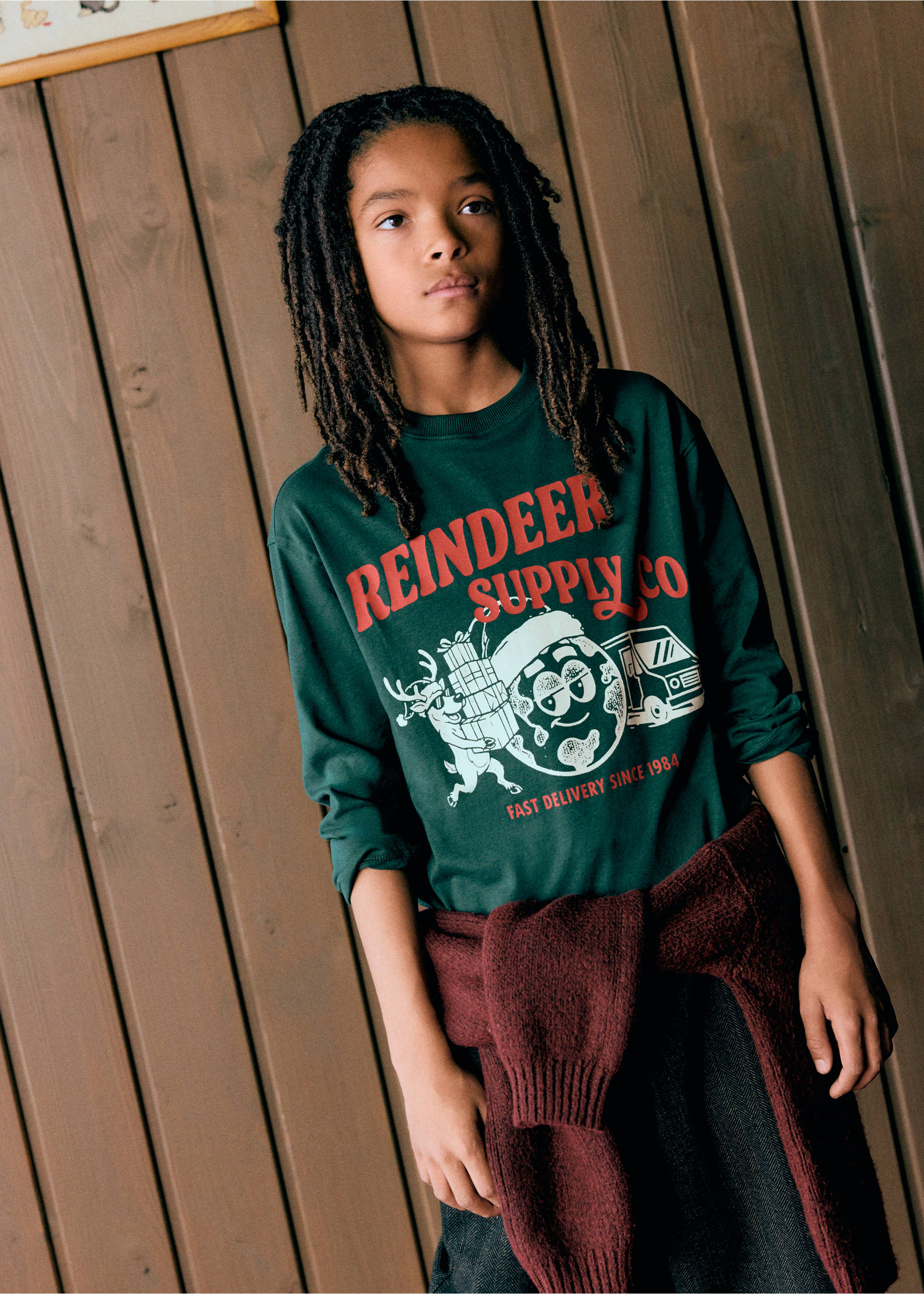 Dark green long-sleeved t-shirt with a festive Reindeer Supply Co graphic print., Dark Green. Ref: 37019214-00.