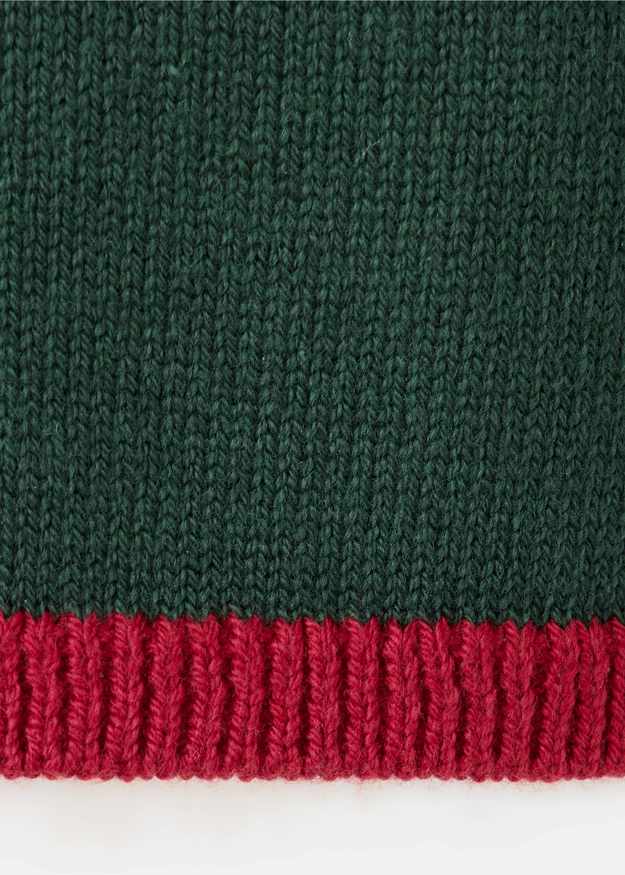 Close-up of a dark green knit jumper with a red ribbed hem., Green. Ref: 37019221-00.