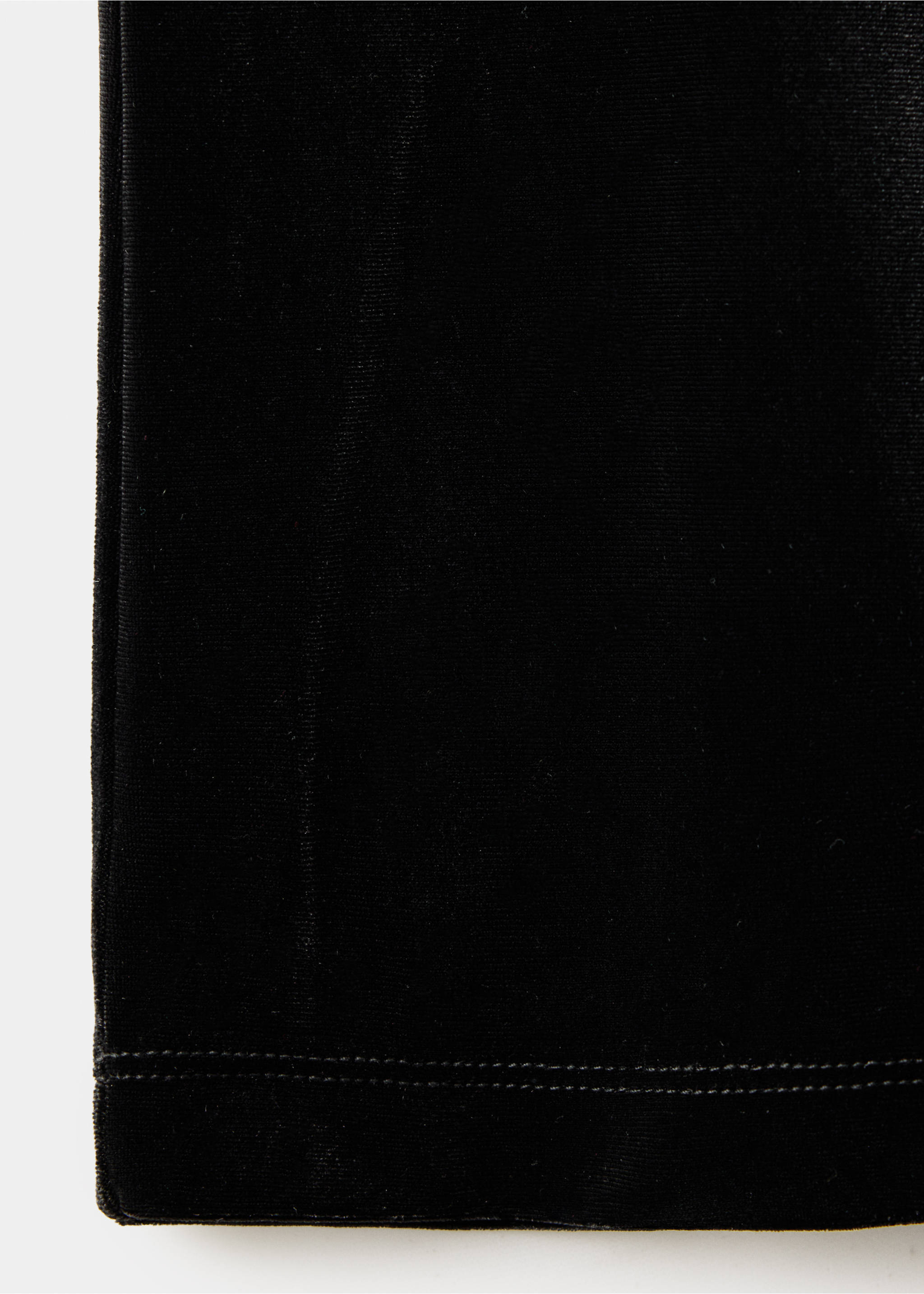 Close-up of black velvet trousers fabric detail showing texture and hem stitching., Black. Ref: 37019223-00.