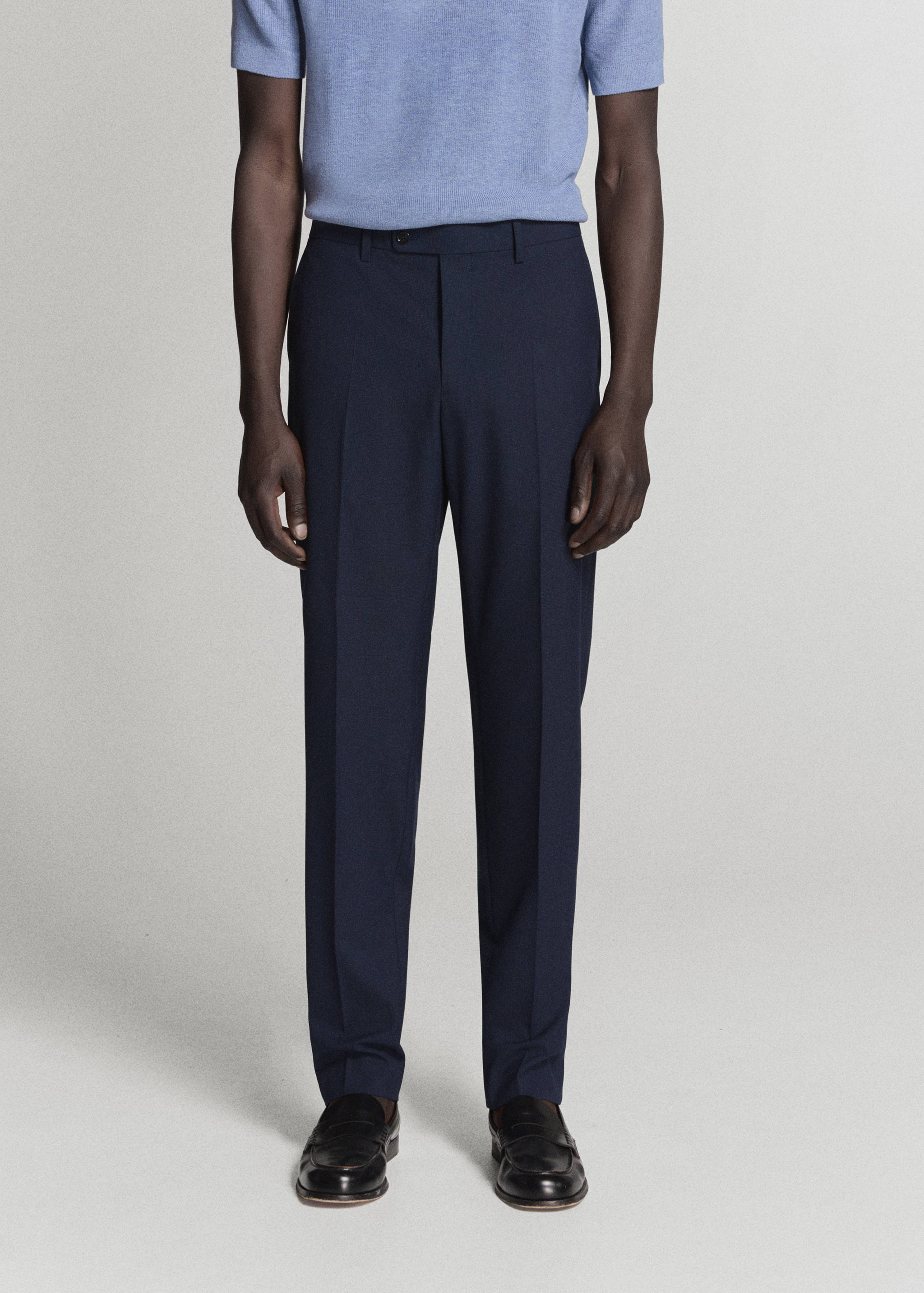 Navy blue tailored trousers with pressed creases.