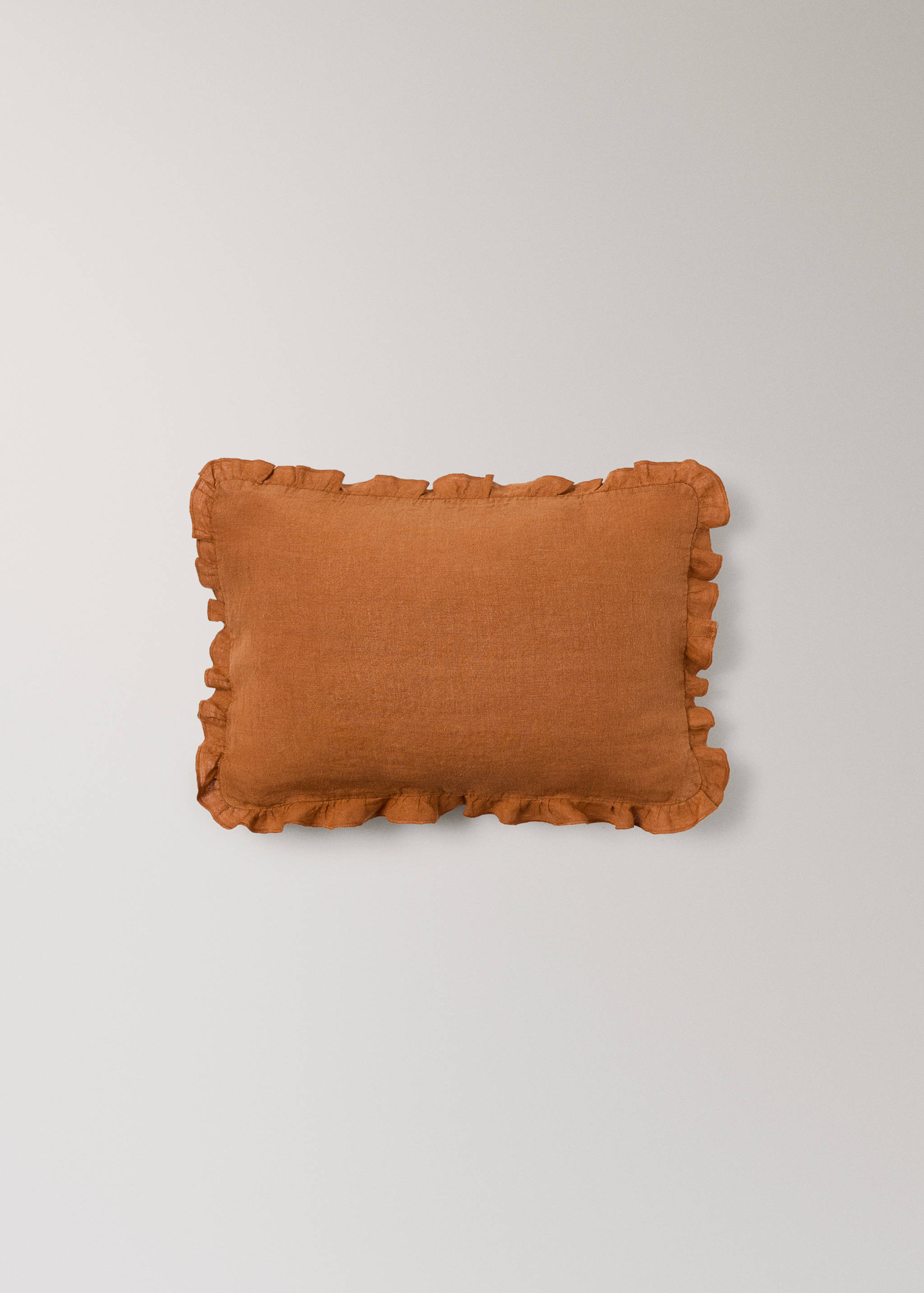 Terracotta orange cushion cover with a ruffled border.