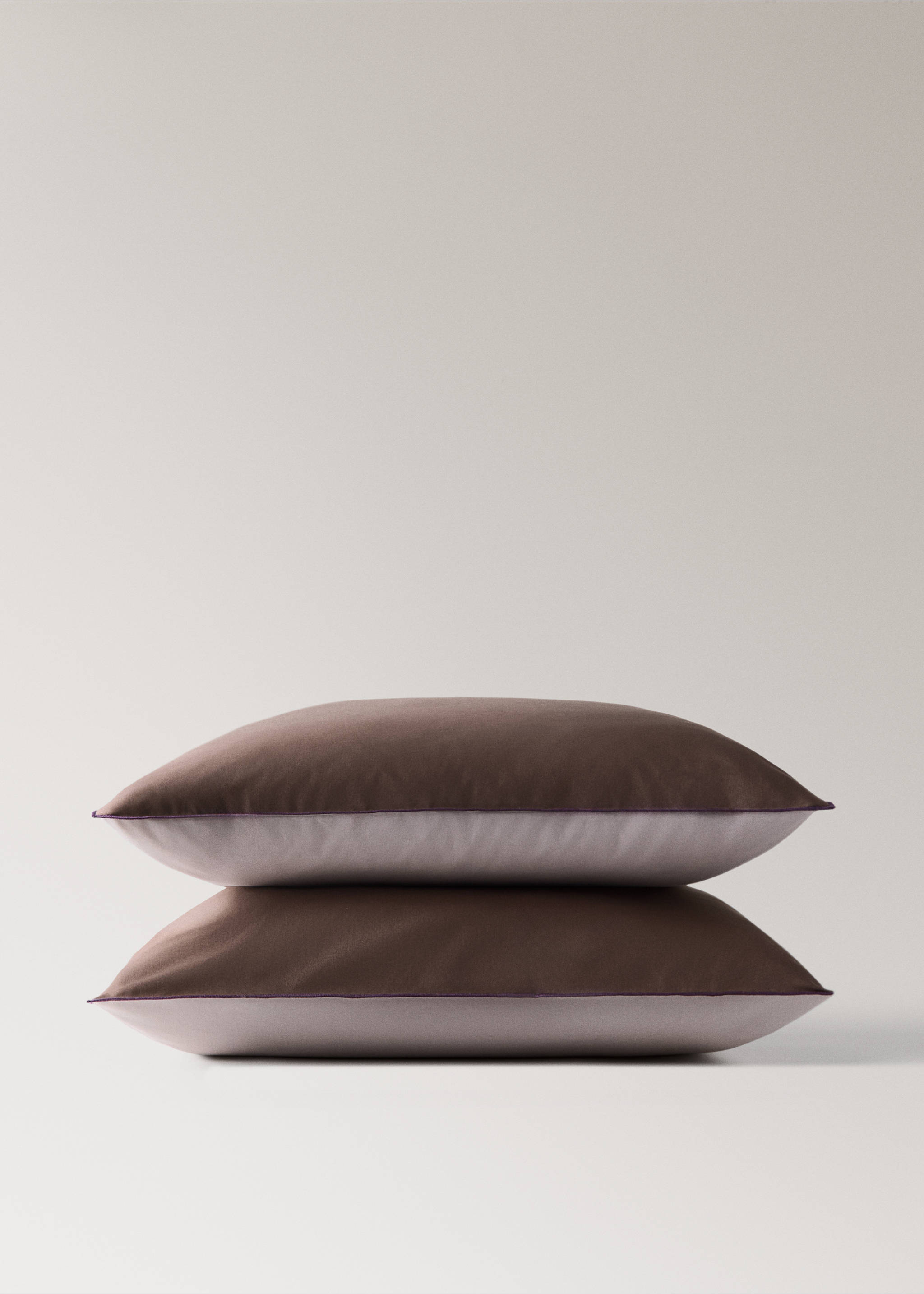 Brown and lilac pillowcases stacked with purple piped trim., Brown. Ref: 37022971-00.