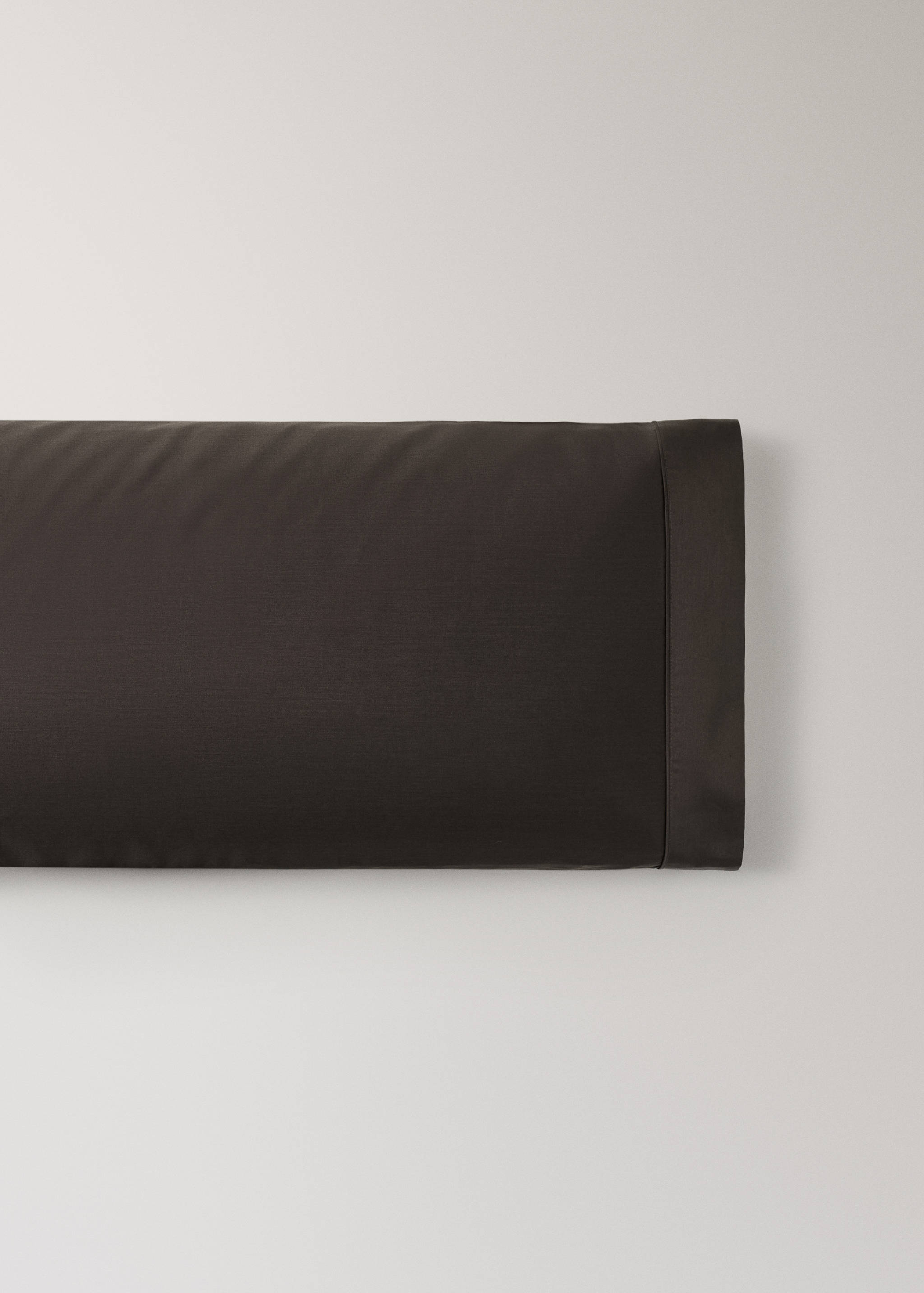 Dark brown pillowcase with a border trim detail.