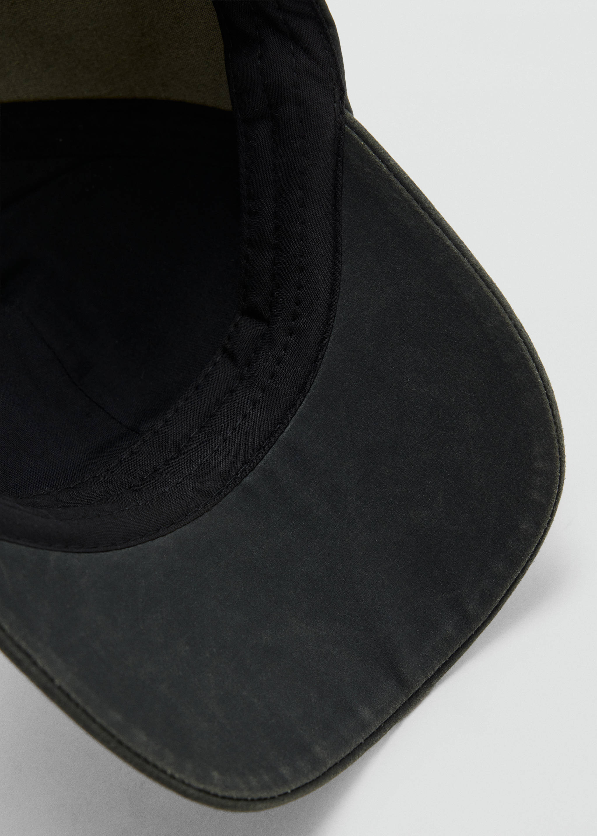 Close-up of the inner detail of a dark grey cap.