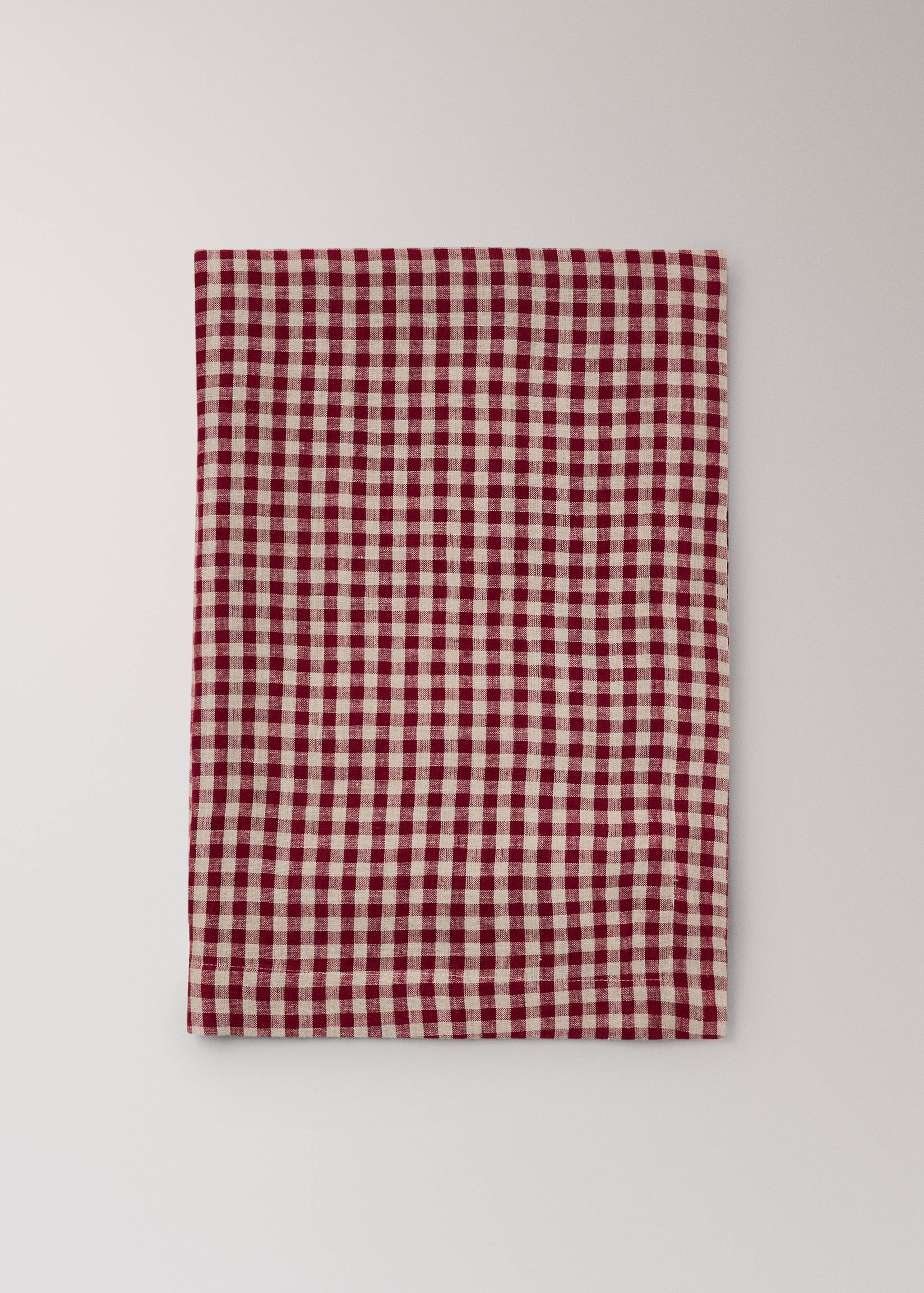 Red and white checked tablecloth in a flat lay view.