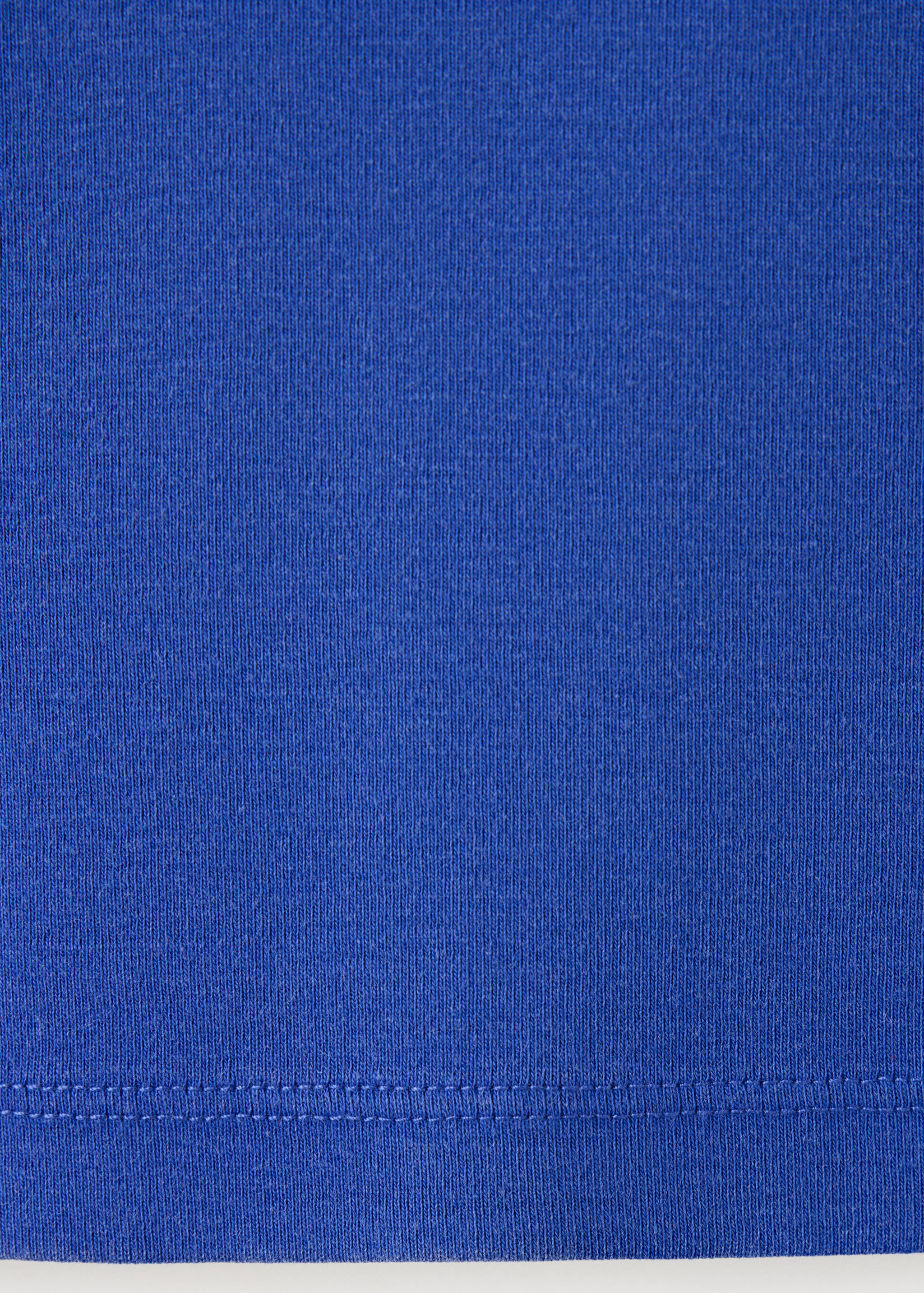 Close-up of the royal blue t-shirt fabric texture and hem detail.
