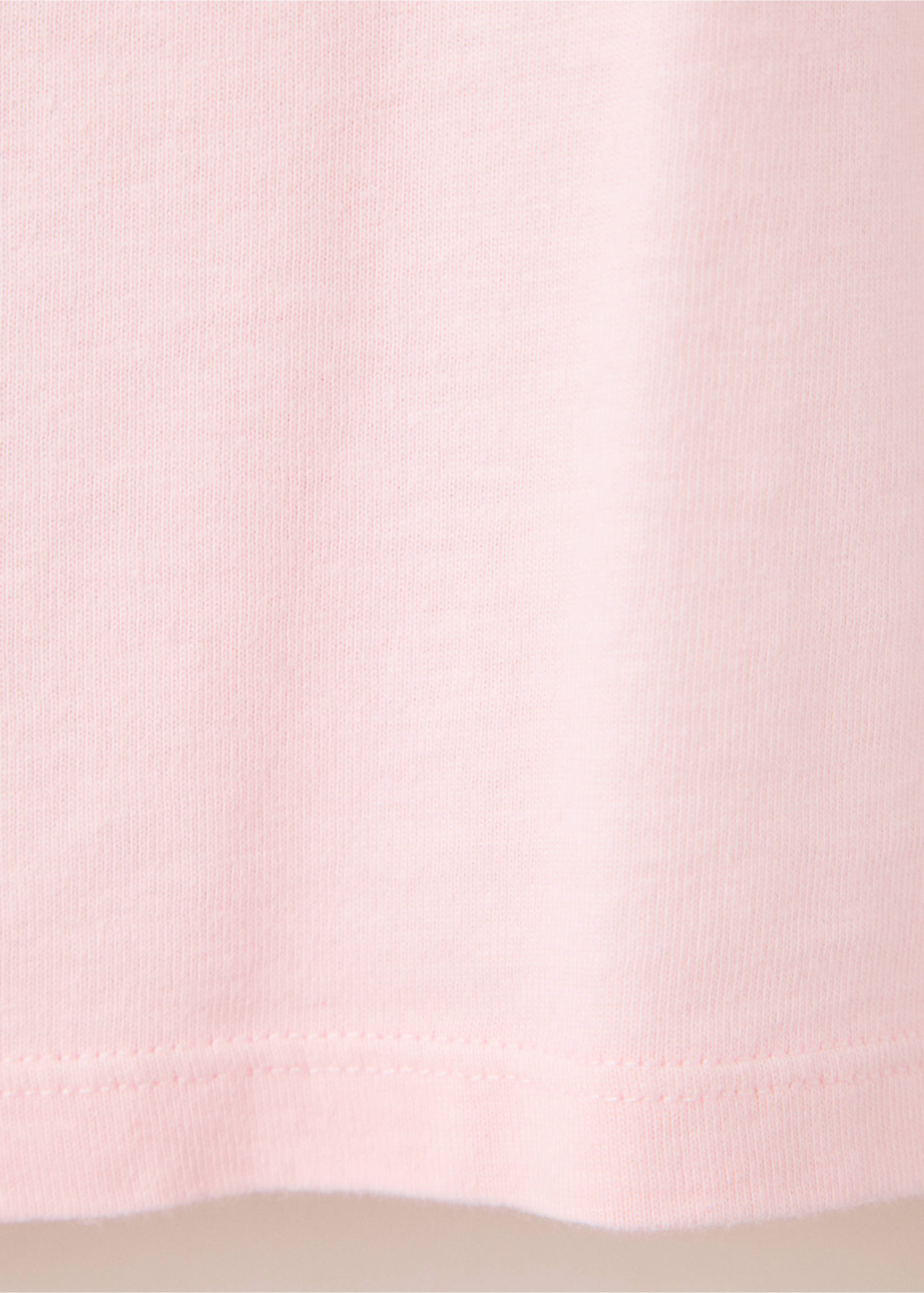 Close-up of the light pink fabric and hem of a t-shirt., Pink. Ref: 37026743-00.