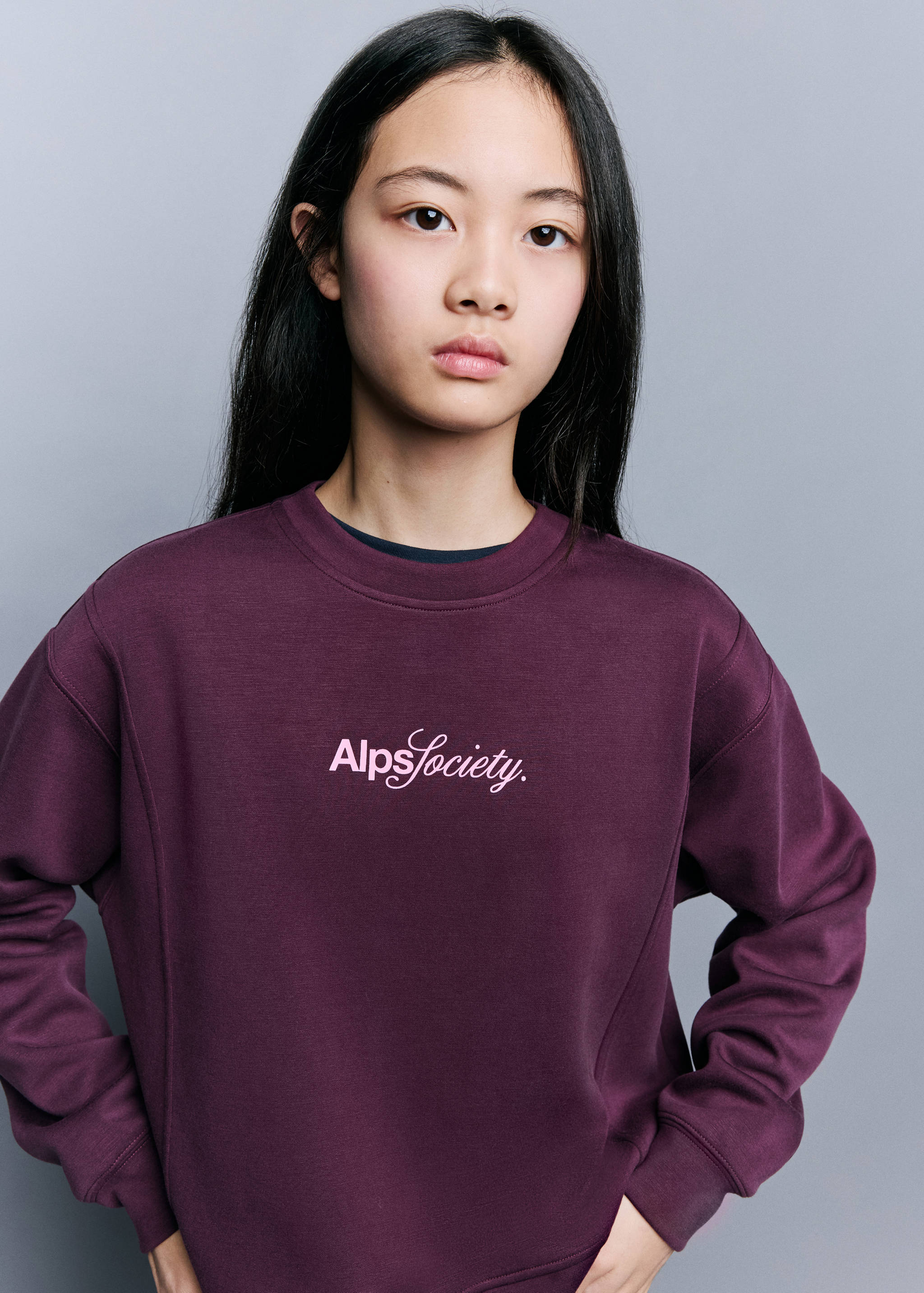 Dark plum sweatshirt featuring a crew neck and white chest embroidery.