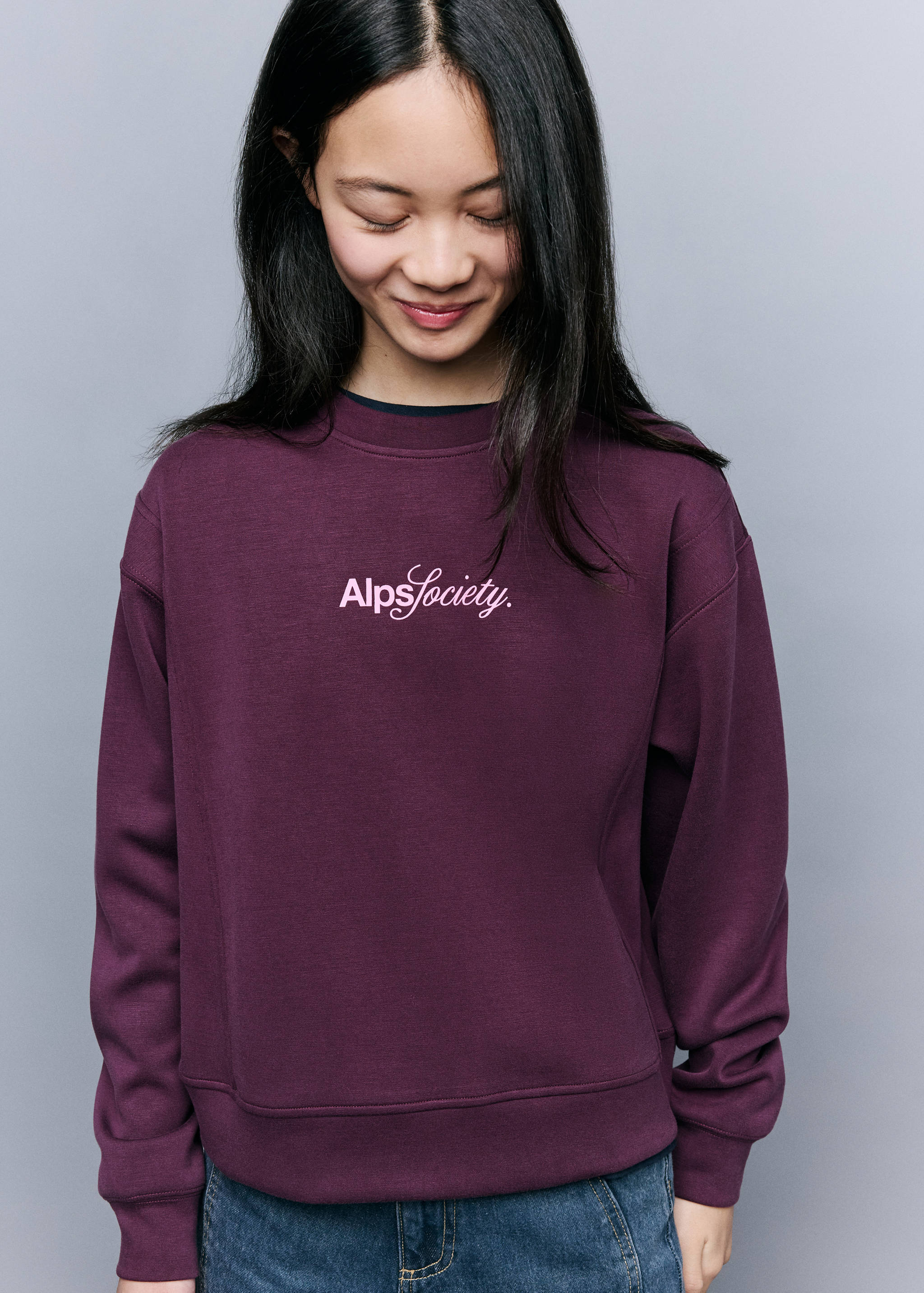 Plum purple sweatshirt with crew neck and white chest logo.