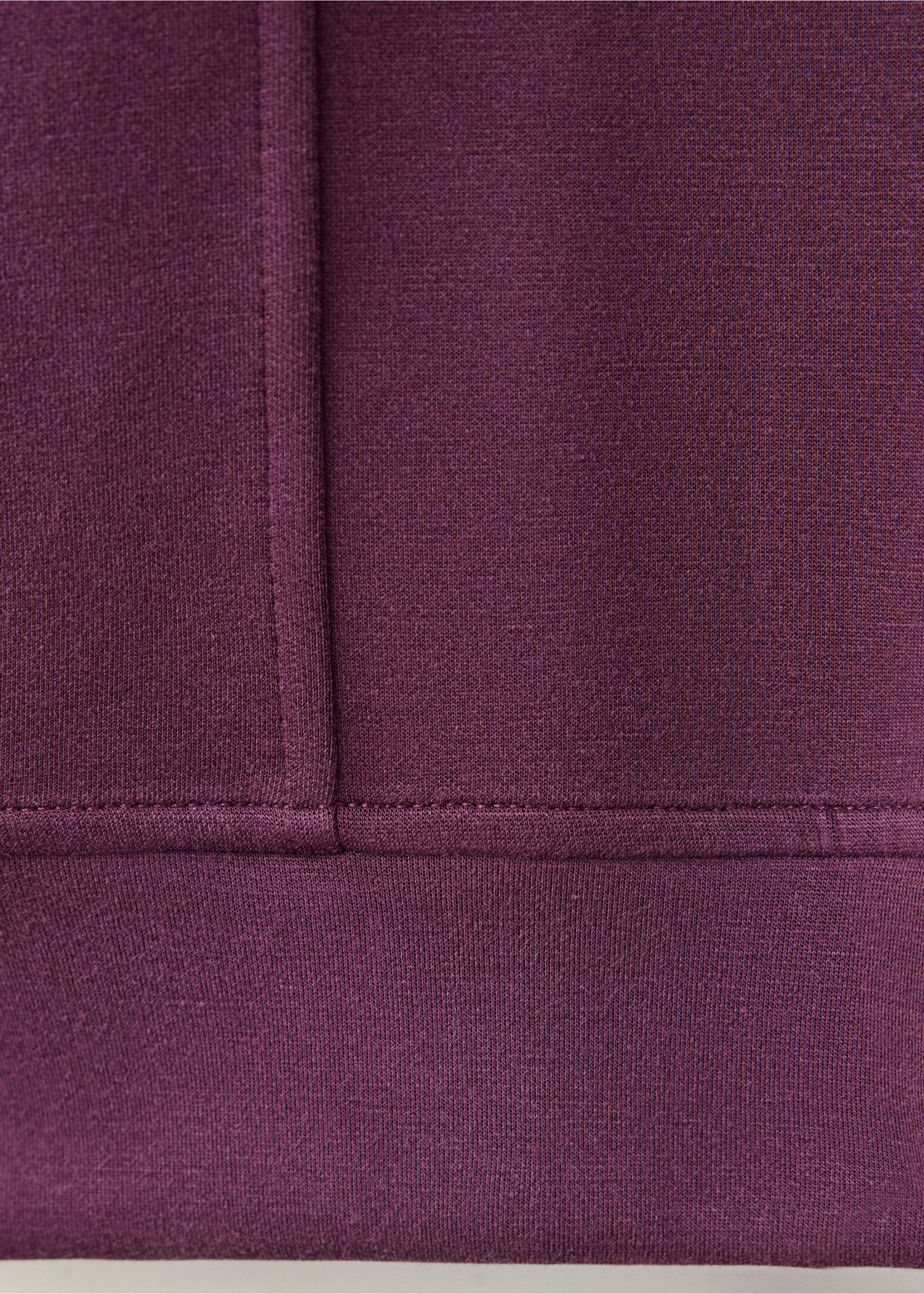 Close-up of plum sweatshirt fabric texture and ribbed hem, Dark Red. Ref: 37026748-00.