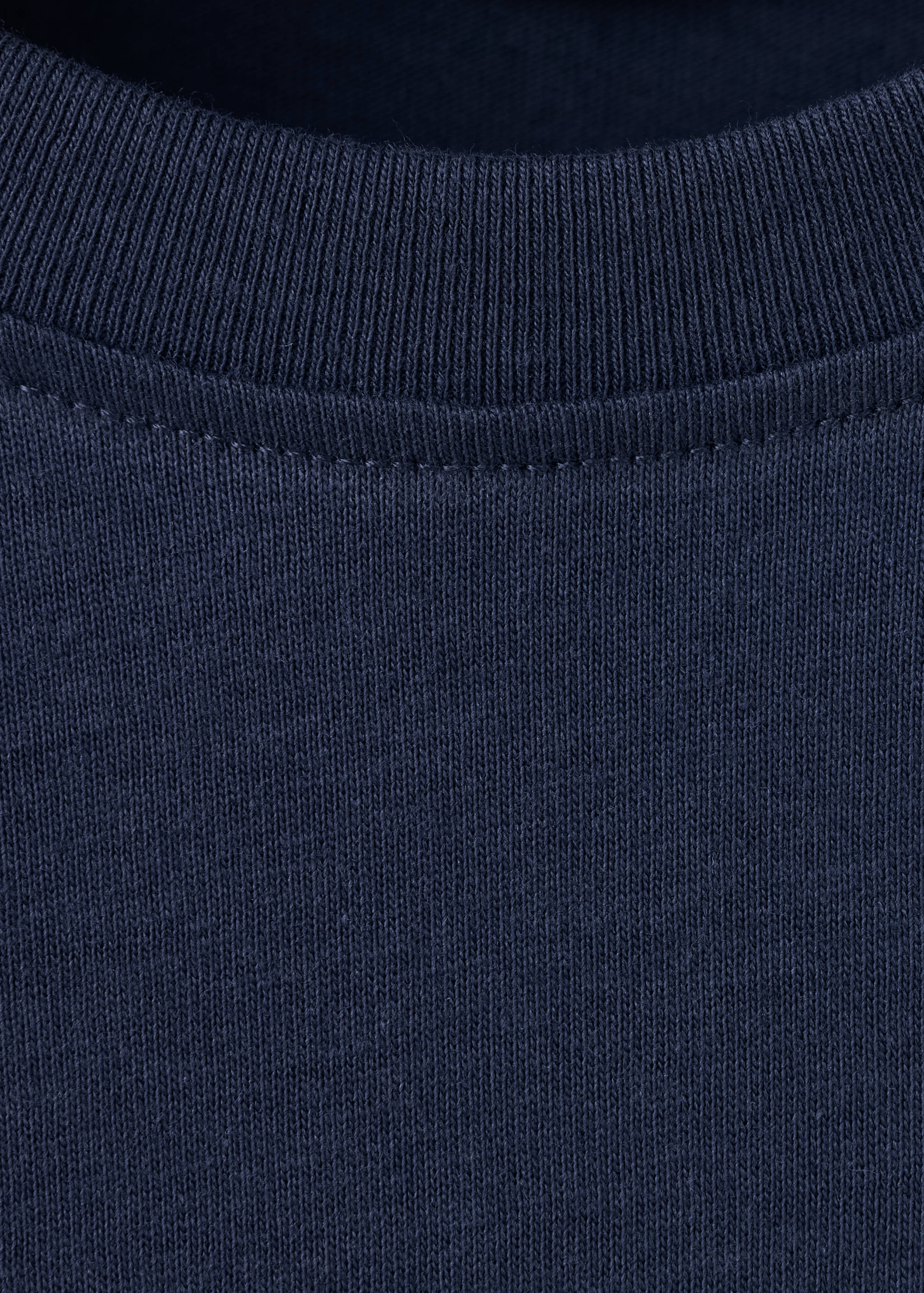 Close-up of the dark navy t-shirt ribbed crew neckline.