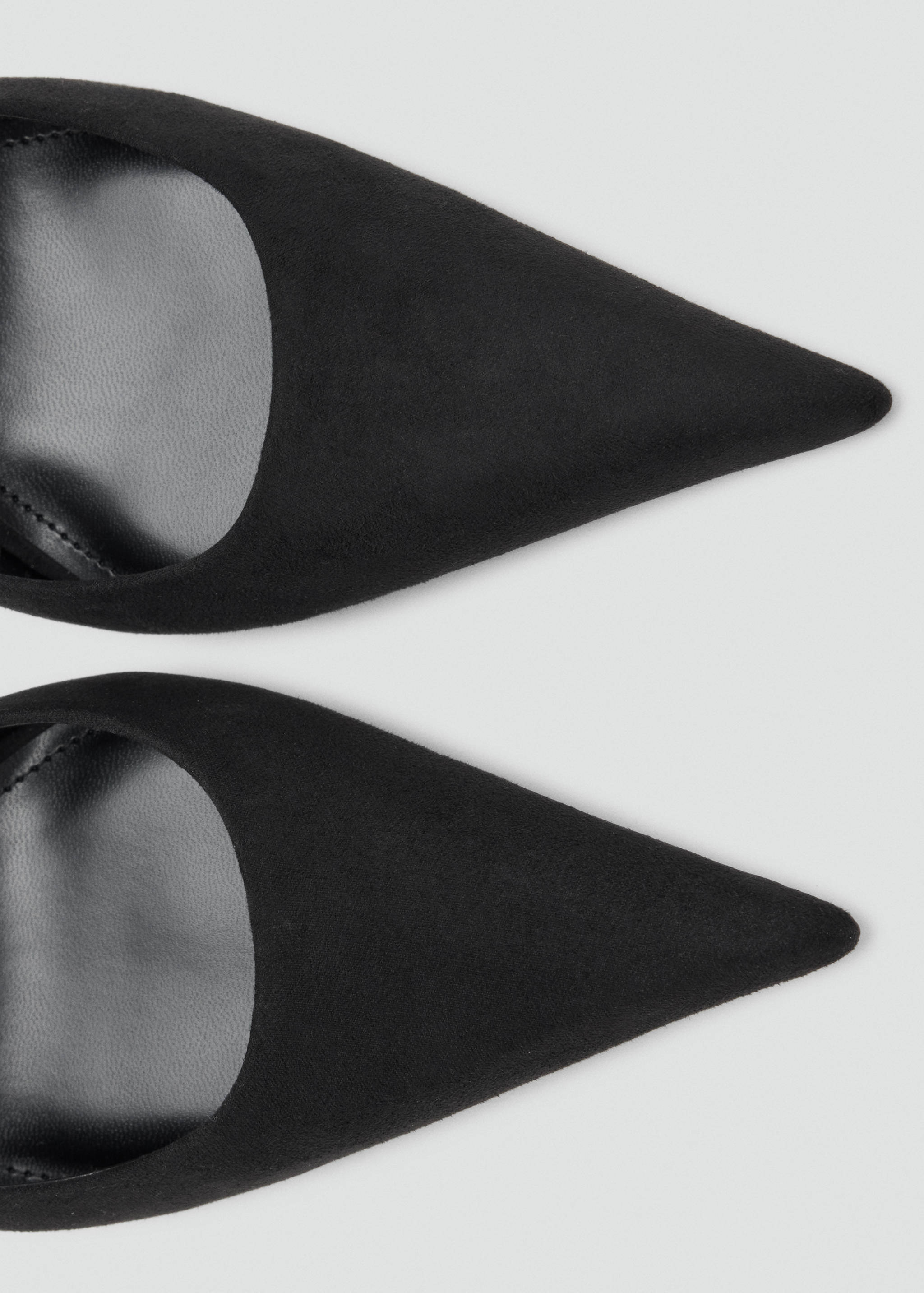 Close-up of black pointed shoes.