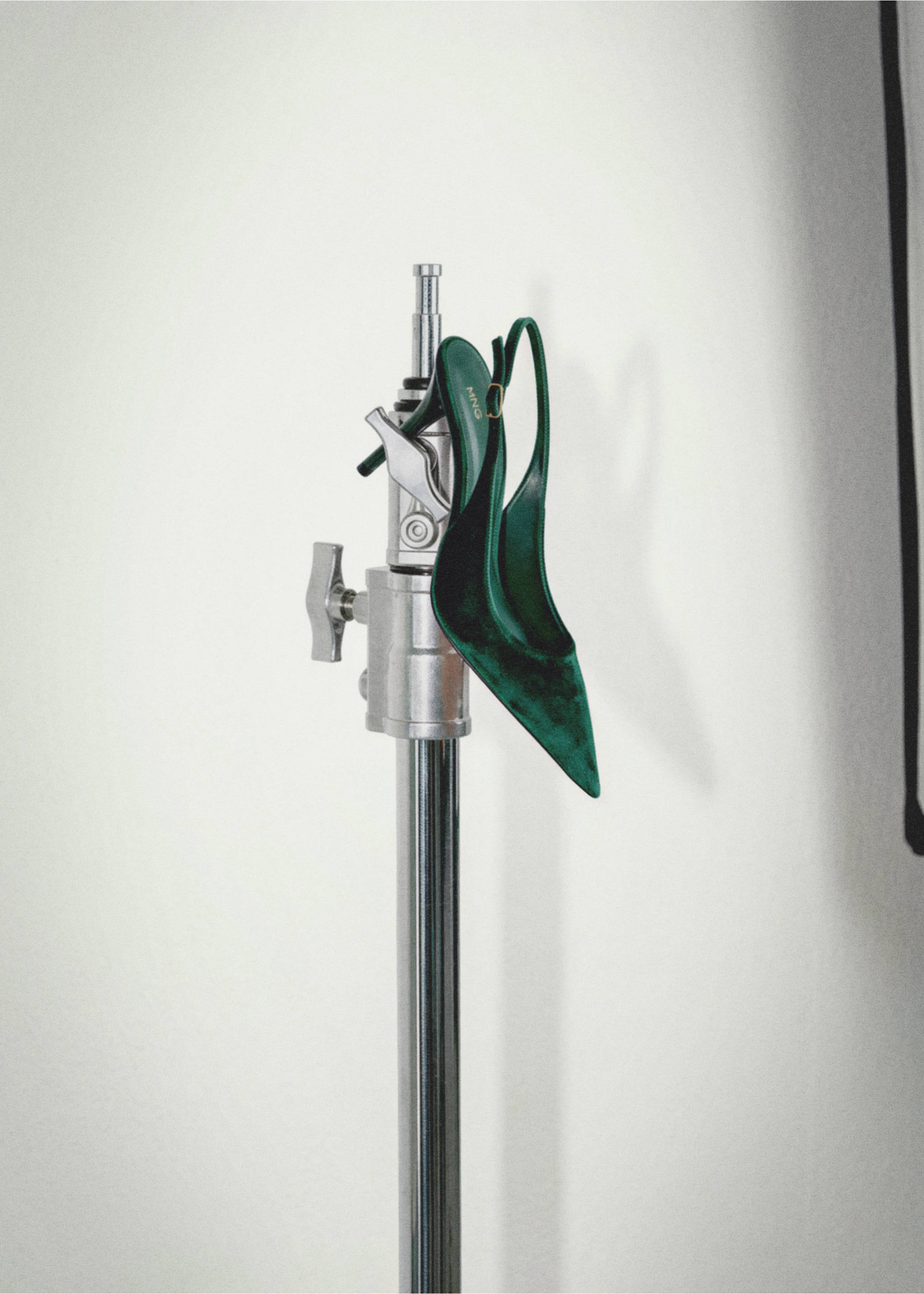 Dark green velvet slingback shoes hung on a studio light stand., Green. Ref: 37027781-00.