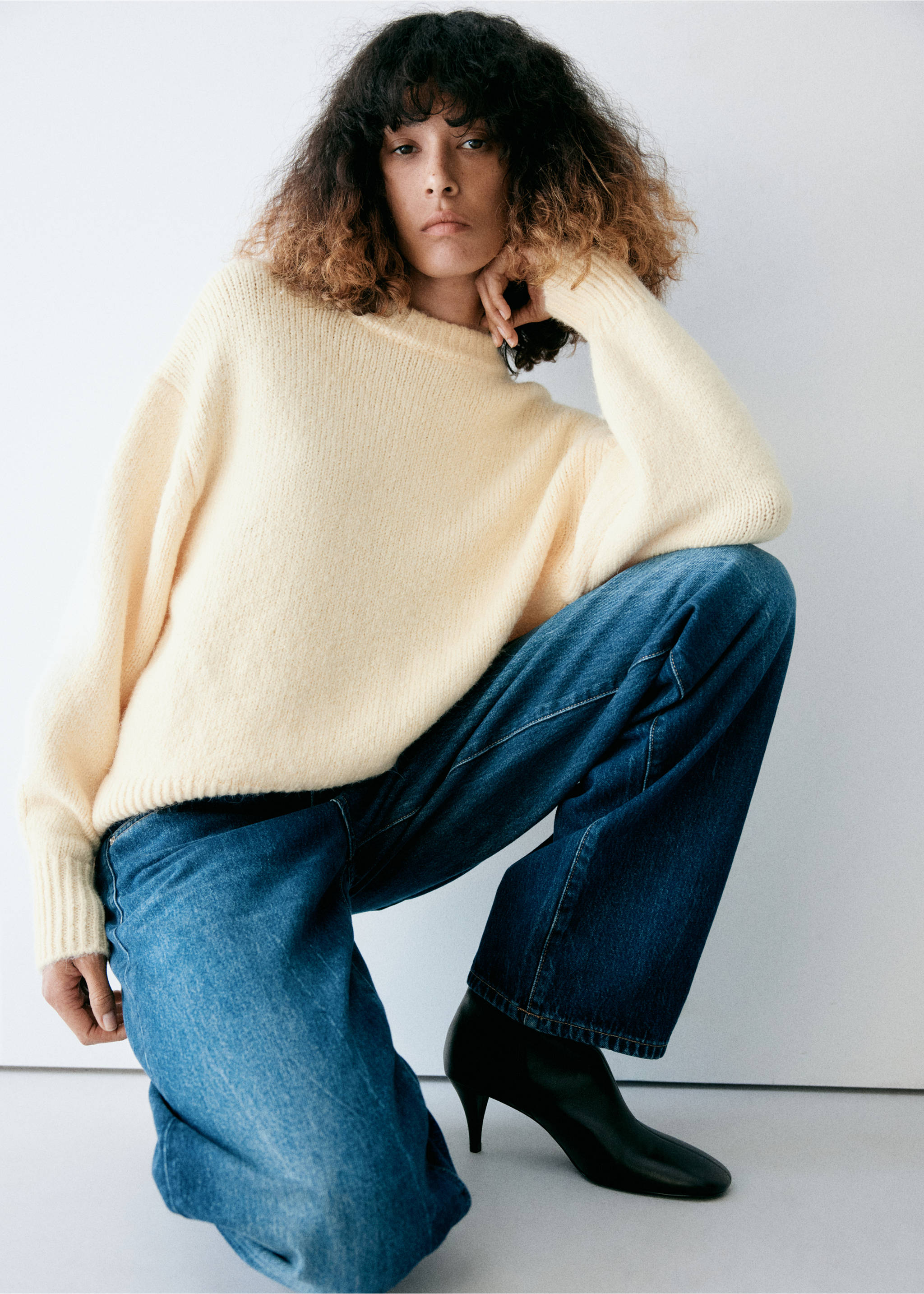 Pale yellow knit jumper with a rounded ribbed neckline, worn with blue wide-leg trousers., Pastel Yellow. Ref: 37027788-00.