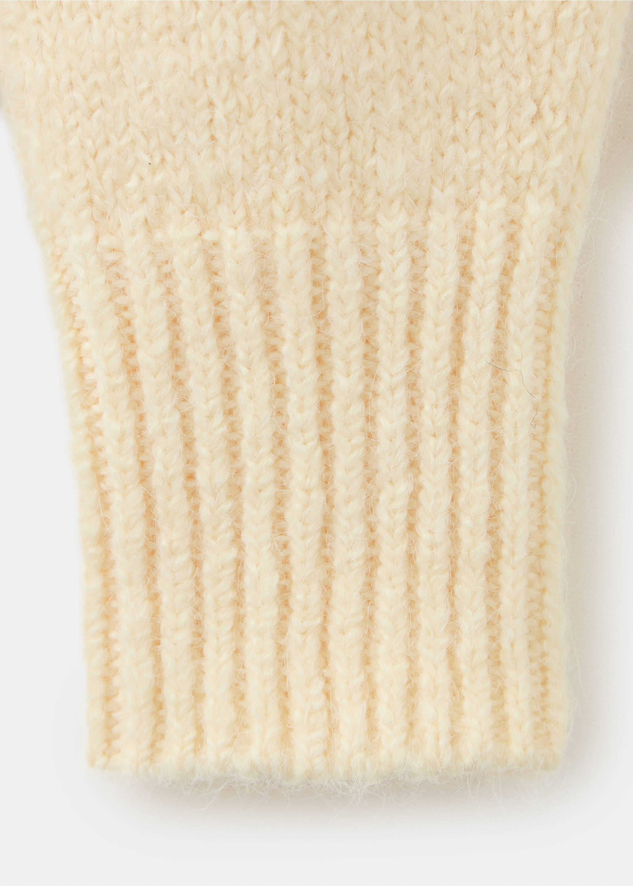 Close-up of the ribbed cuff and fuzzy knit texture of a cream jersey., Pastel Yellow. Ref: 37027788-00.