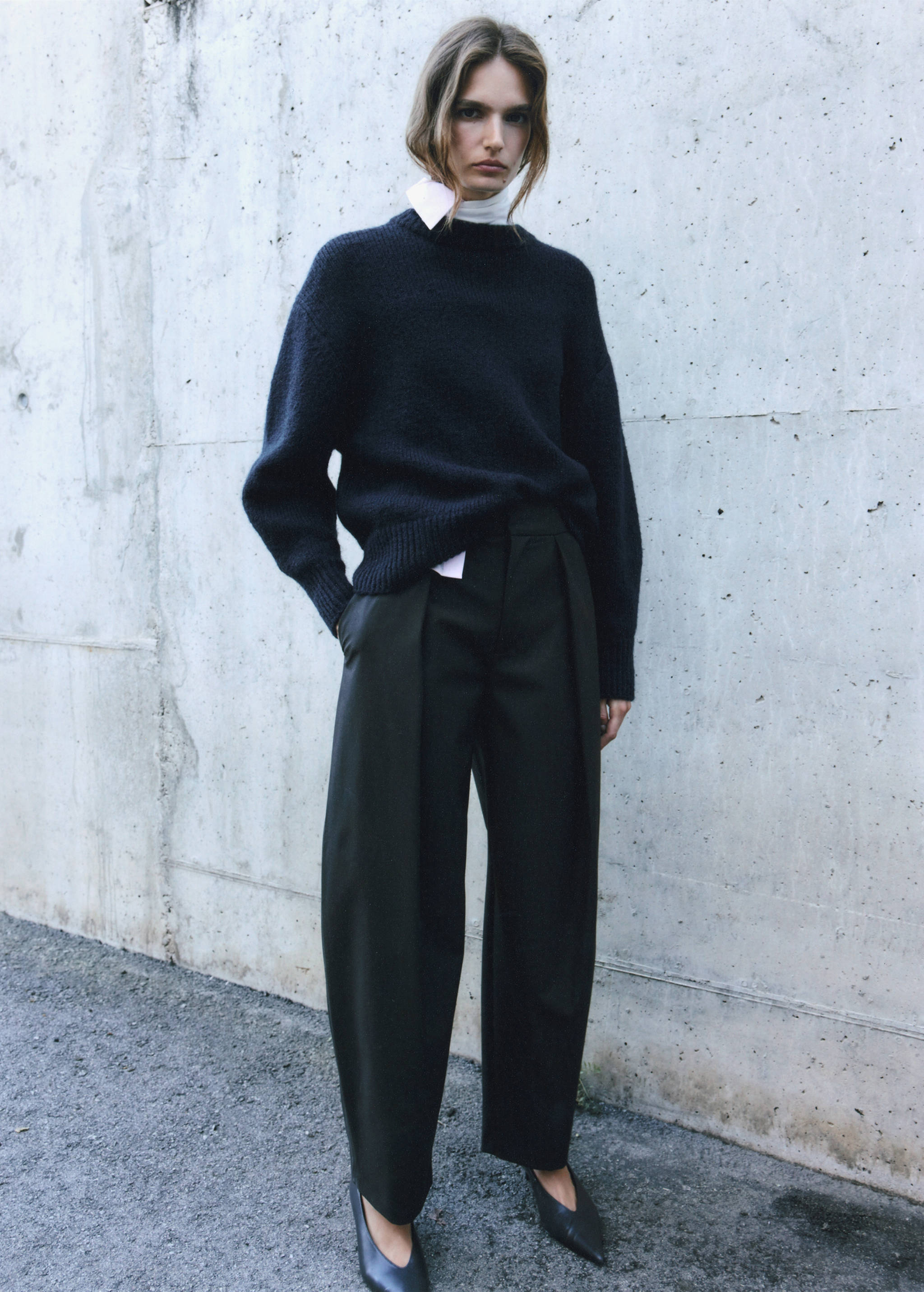 Navy blue knitted jumper with a ribbed crew neck and relaxed fit.