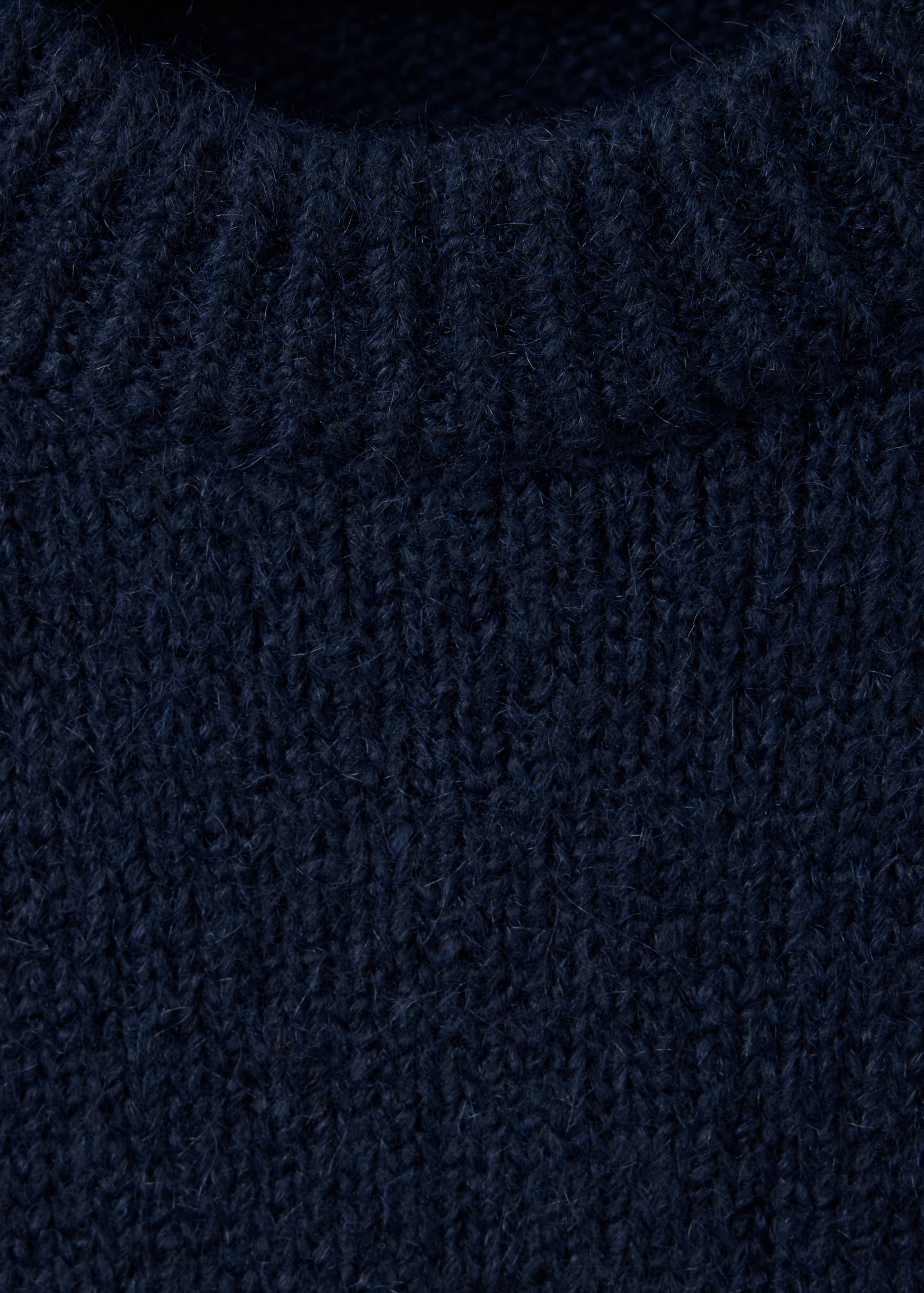Dark navy blue knitted jersey with a ribbed round neckline, close-up view.