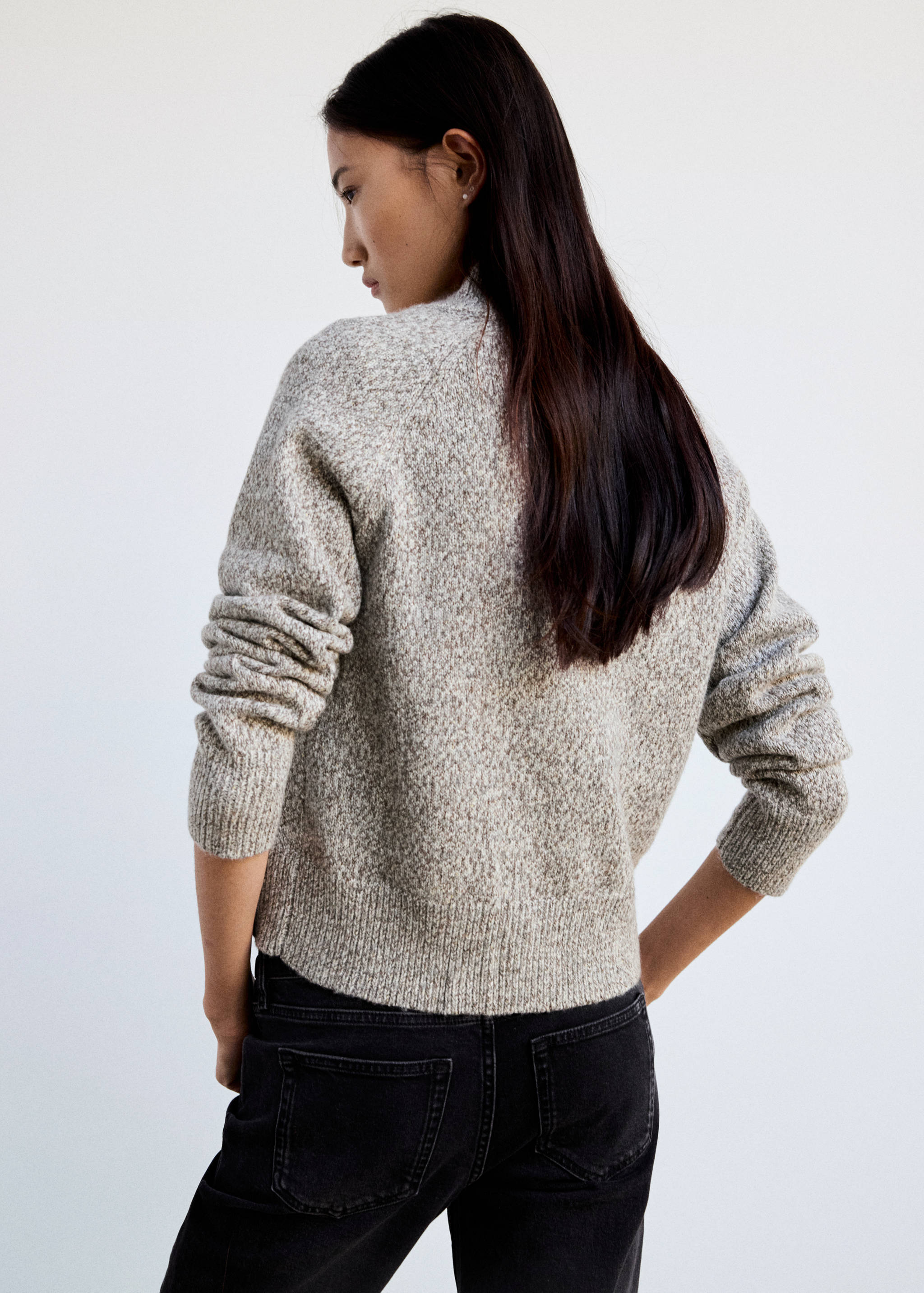 Beige knit cardigan with a high neck, shown from the back.