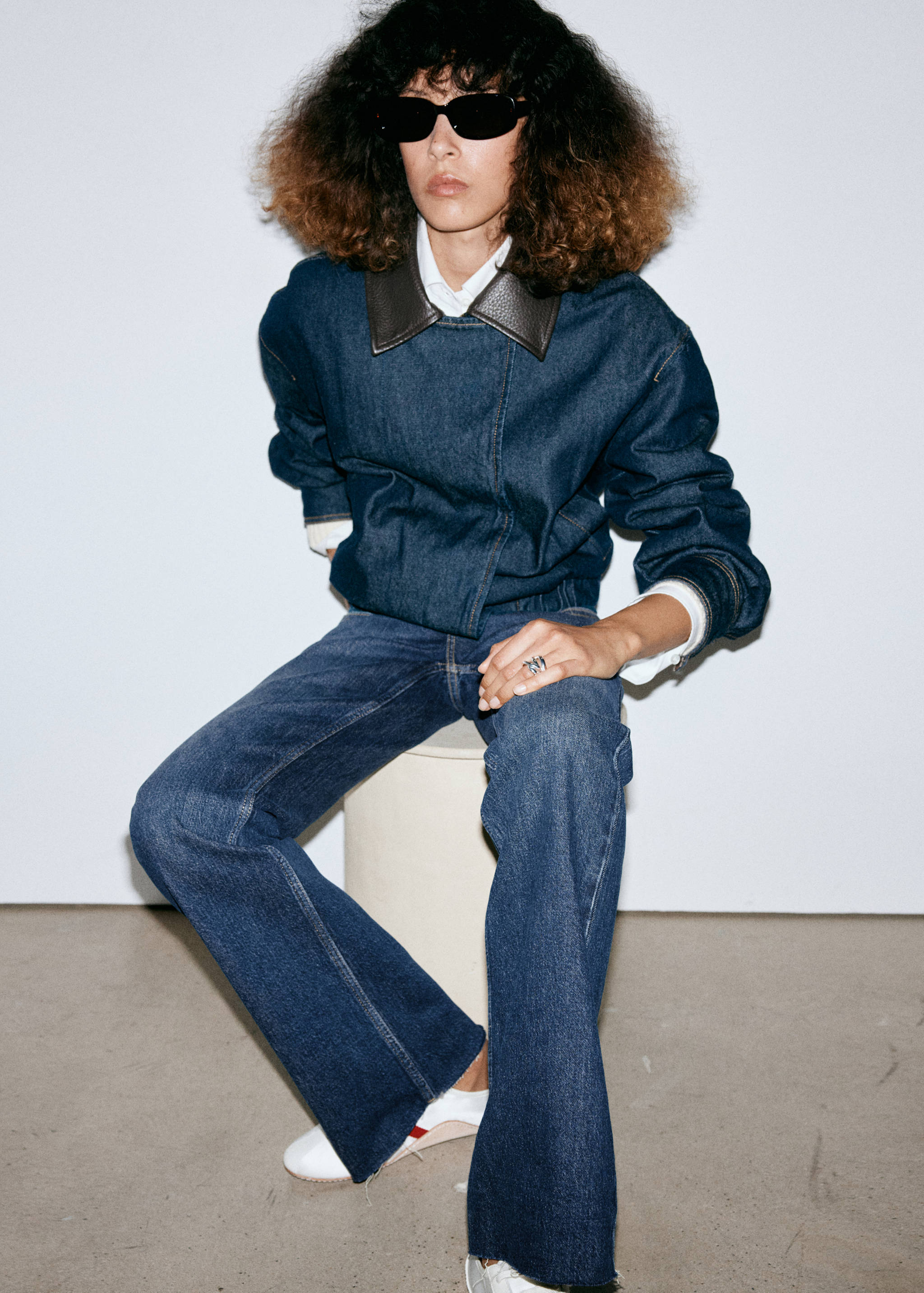 Dark denim jacket with a brown collar and matching denim trousers.
